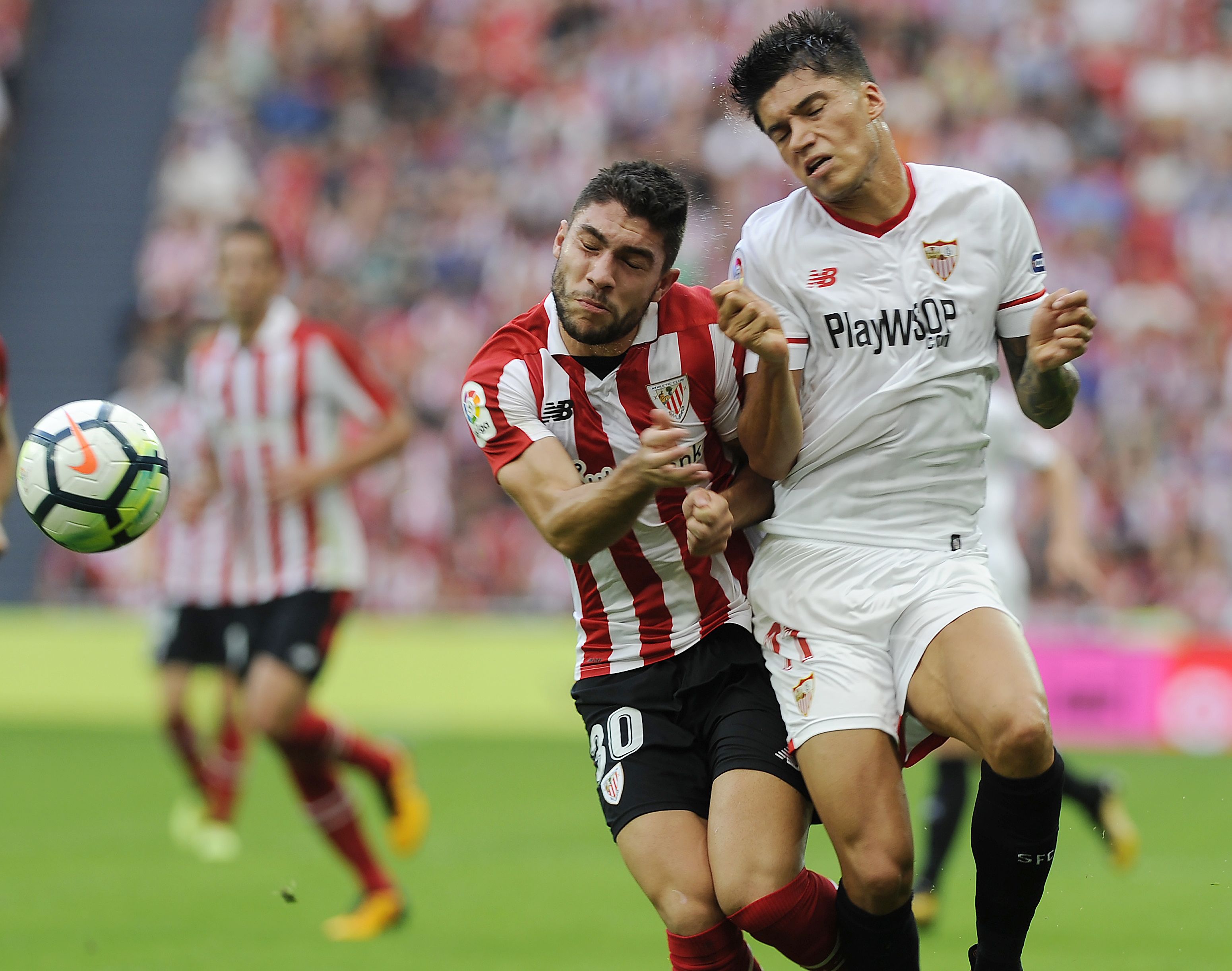 Sevilla's Argentinian midfielder Joaquin Correa (R) challenges Athletic Bilbao's Spanish defender Unai Nunez during the Spanish league football match Athletic Club Bilbao vs Sevilla FC at the San Mames stadium in Bilbao on October 14, 2017. / AFP PHOTO / ANDER GILLENEA        (Photo credit should read ANDER GILLENEA/AFP/Getty Images)