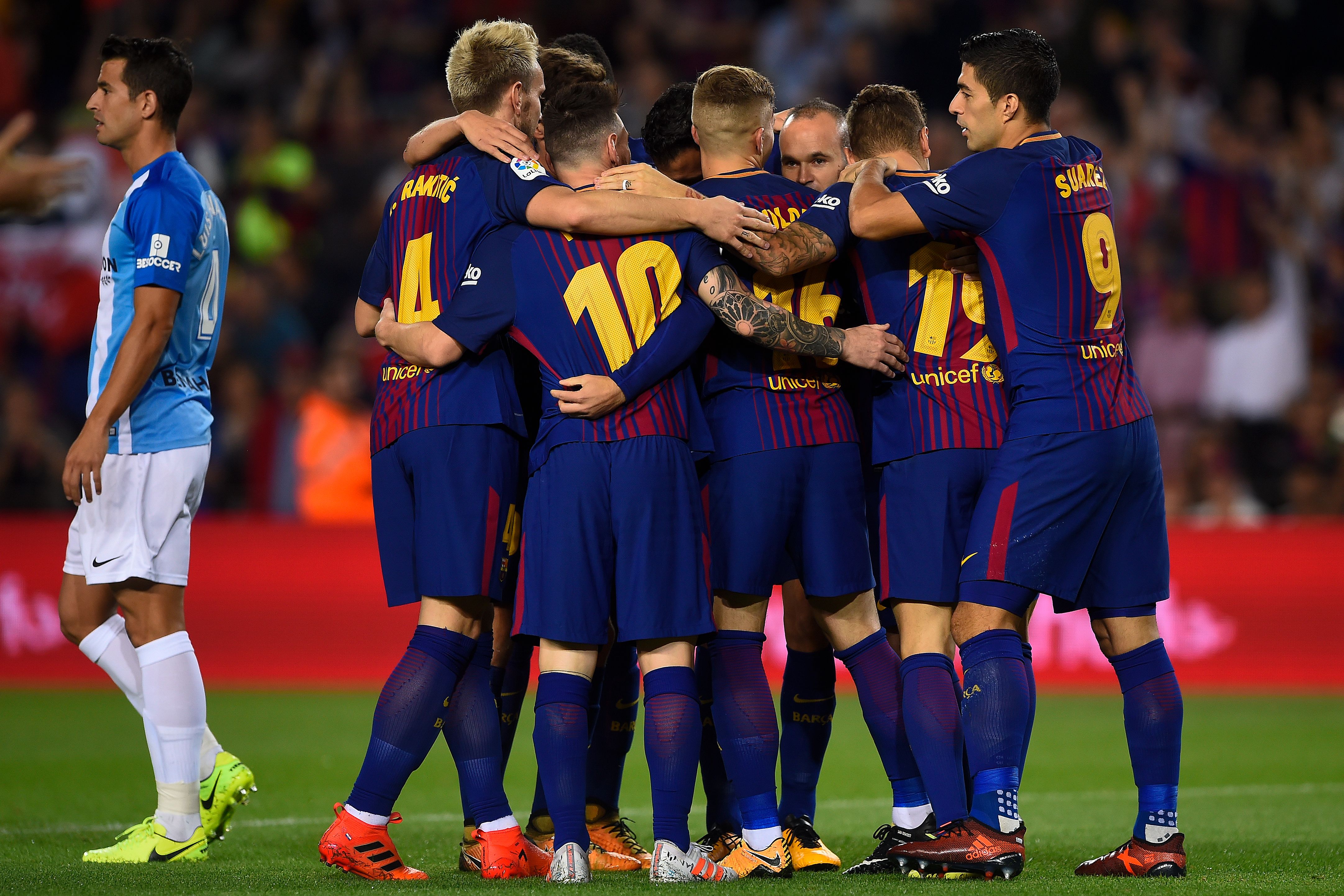 Barcelona's players celebrate after scoring a goal during the Spanish league football match FC Barcelona vs Malaga CF at the Camp Nou stadium in Barcelona on October 21, 2017. / AFP PHOTO / Josep LAGO        (Photo credit should read JOSEP LAGO/AFP/Getty Images)