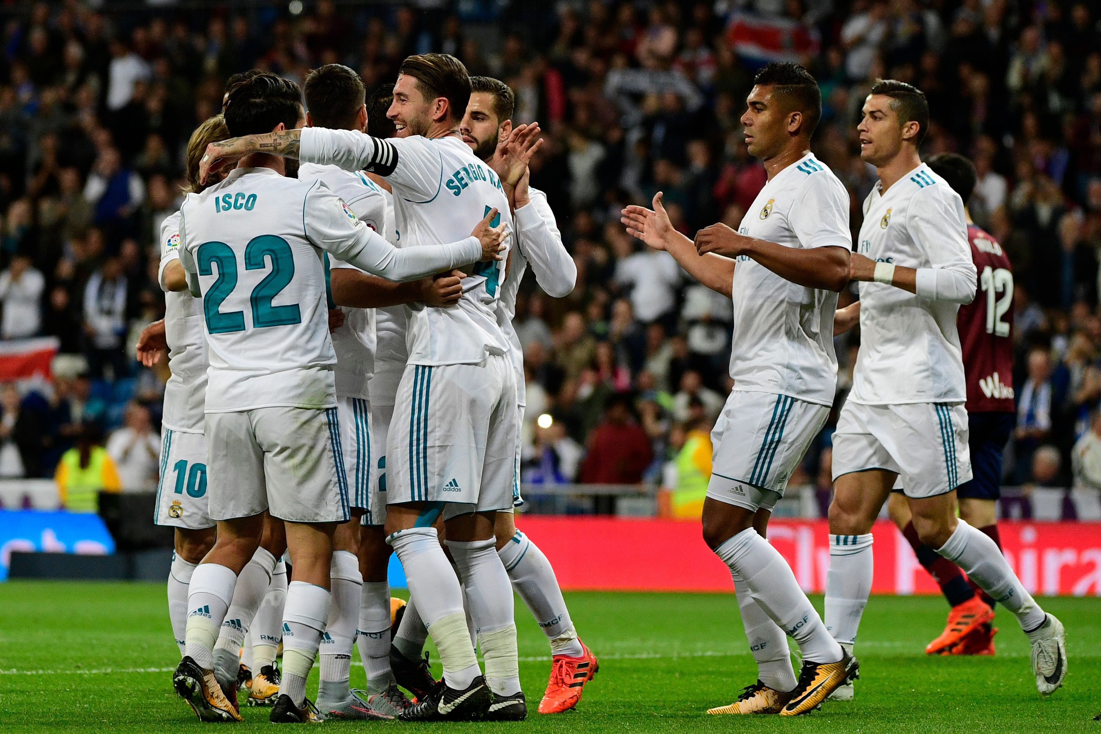 Real Madrid's players celebrate a goal during the Spanish league football match Real Madrid CF vs SD Eibar at the Santiago Bernabeu stadium in Madrid on October 22, 2017. / AFP PHOTO / PIERRE-PHILIPPE MARCOU        (Photo credit should read PIERRE-PHILIPPE MARCOU/AFP/Getty Images)