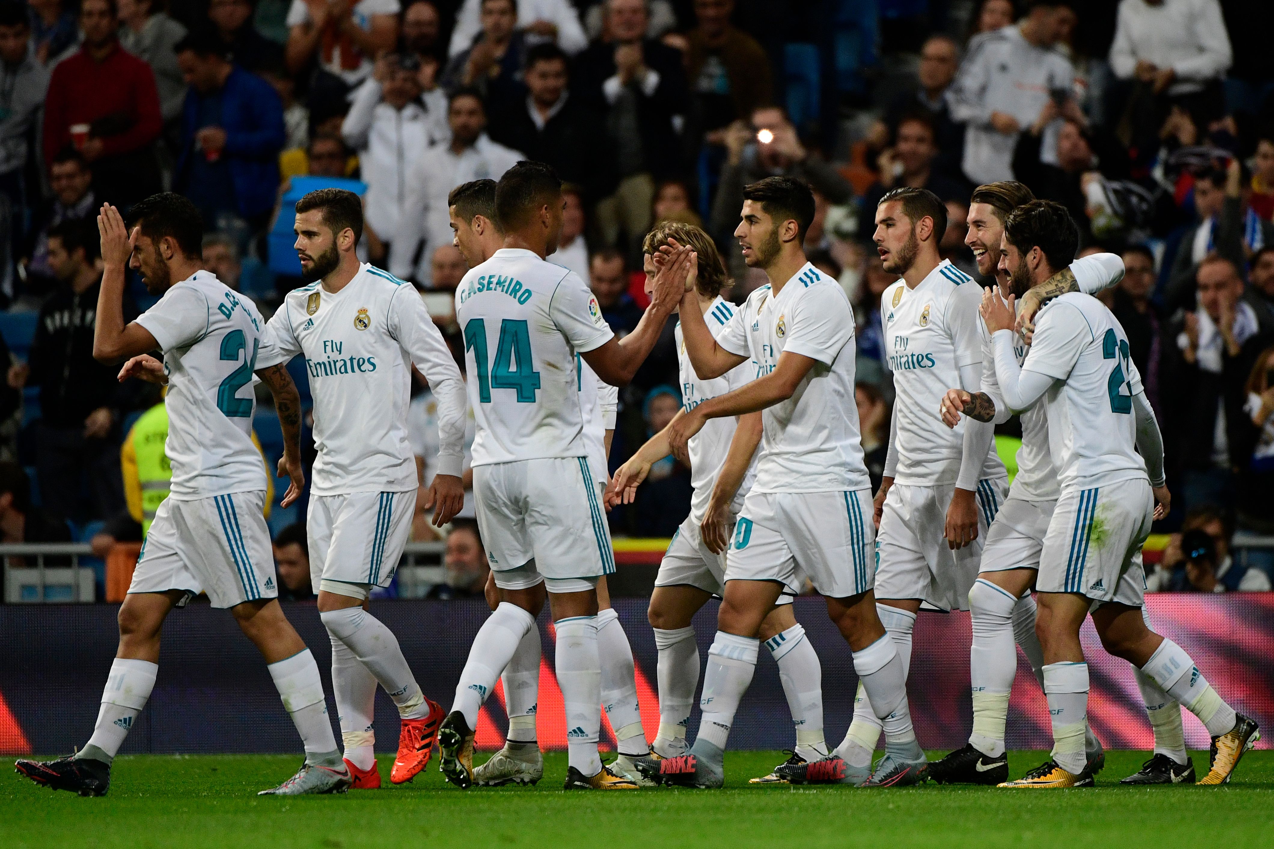 Real Madrid's players celebrate their second goal during the Spanish league football match Real Madrid CF vs SD Eibar at the Santiago Bernabeu stadium in Madrid on October 22, 2017. / AFP PHOTO / PIERRE-PHILIPPE MARCOU        (Photo credit should read PIERRE-PHILIPPE MARCOU/AFP/Getty Images)