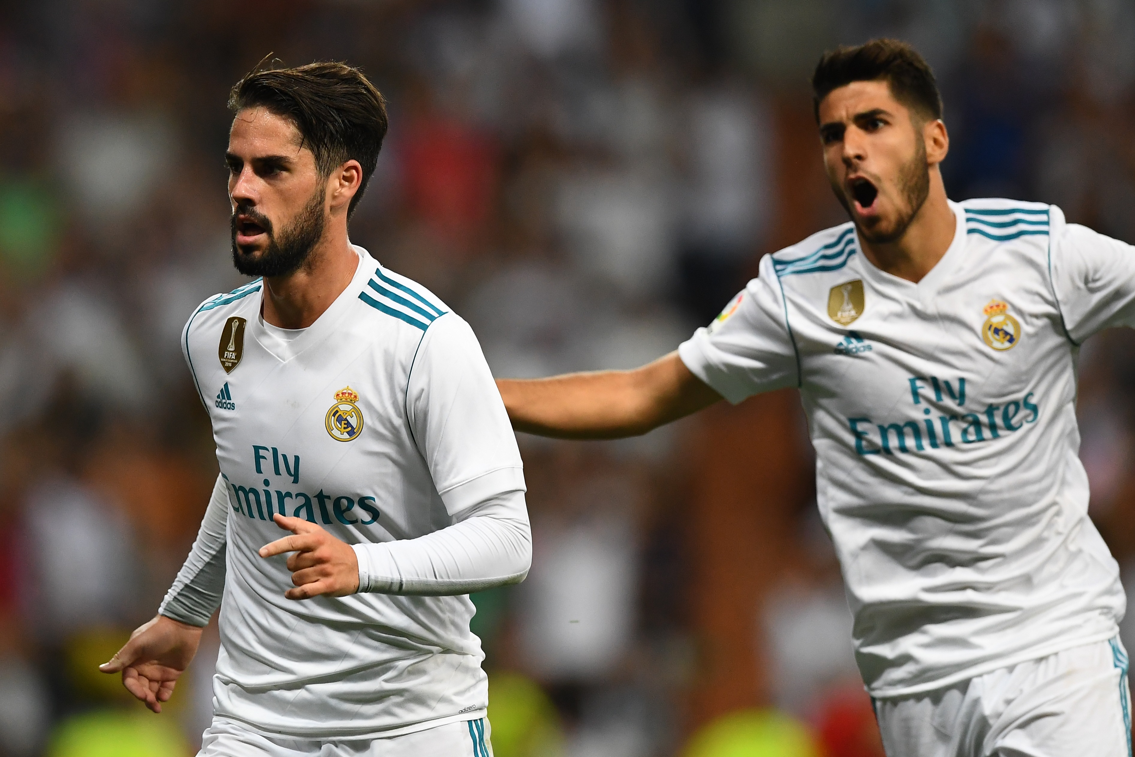 Real Madrid's midfielder Isco (L) celebrates his second goal during the Spanish league football match Real Madrid CF vs RCD Espanyol at the Santiago Bernabeu stadium in Madrid on October 1, 2017. / AFP PHOTO / GABRIEL BOUYS        (Photo credit should read GABRIEL BOUYS/AFP/Getty Images)