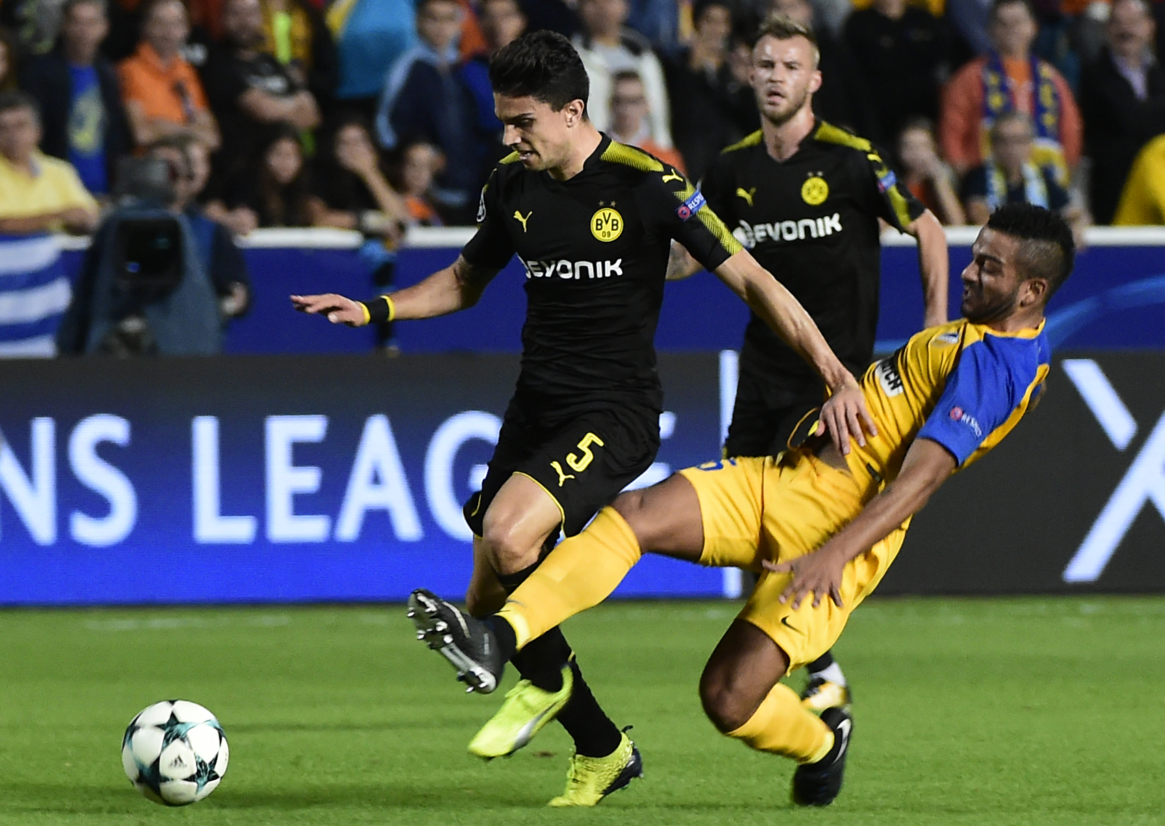 Dortmund's Spanish defender Marc Bartra (L) is tackled by APOEL Nicosia's Dutch forward Lorenzo Ebicilio (R) during the UEFA Champions League football match between Apoel FC and Borussia Dortmund at the GSP Stadium in the Cypriot capital, Nicosia on October 17, 2017.  / AFP PHOTO / KHALED DESOUKI        (Photo credit should read KHALED DESOUKI/AFP/Getty Images)