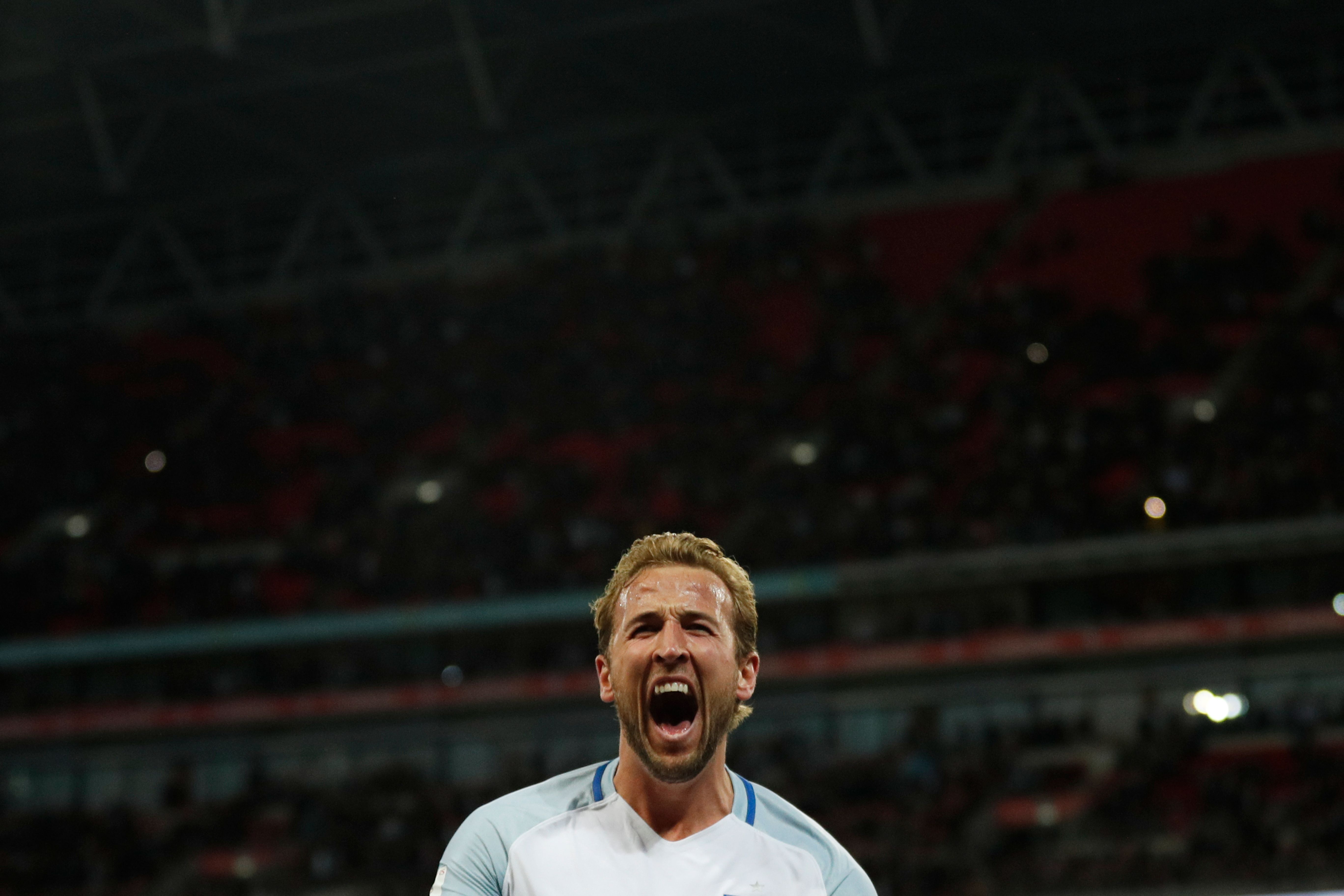 England's striker Harry Kane celebrates scoring the opening goal during the FIFA World Cup 2018 qualification football match between England and Slovenia at Wembley Stadium in London on October 5, 2017.  / AFP PHOTO / Adrian DENNIS / NOT FOR MARKETING OR ADVERTISING USE / RESTRICTED TO EDITORIAL USE        (Photo credit should read ADRIAN DENNIS/AFP/Getty Images)