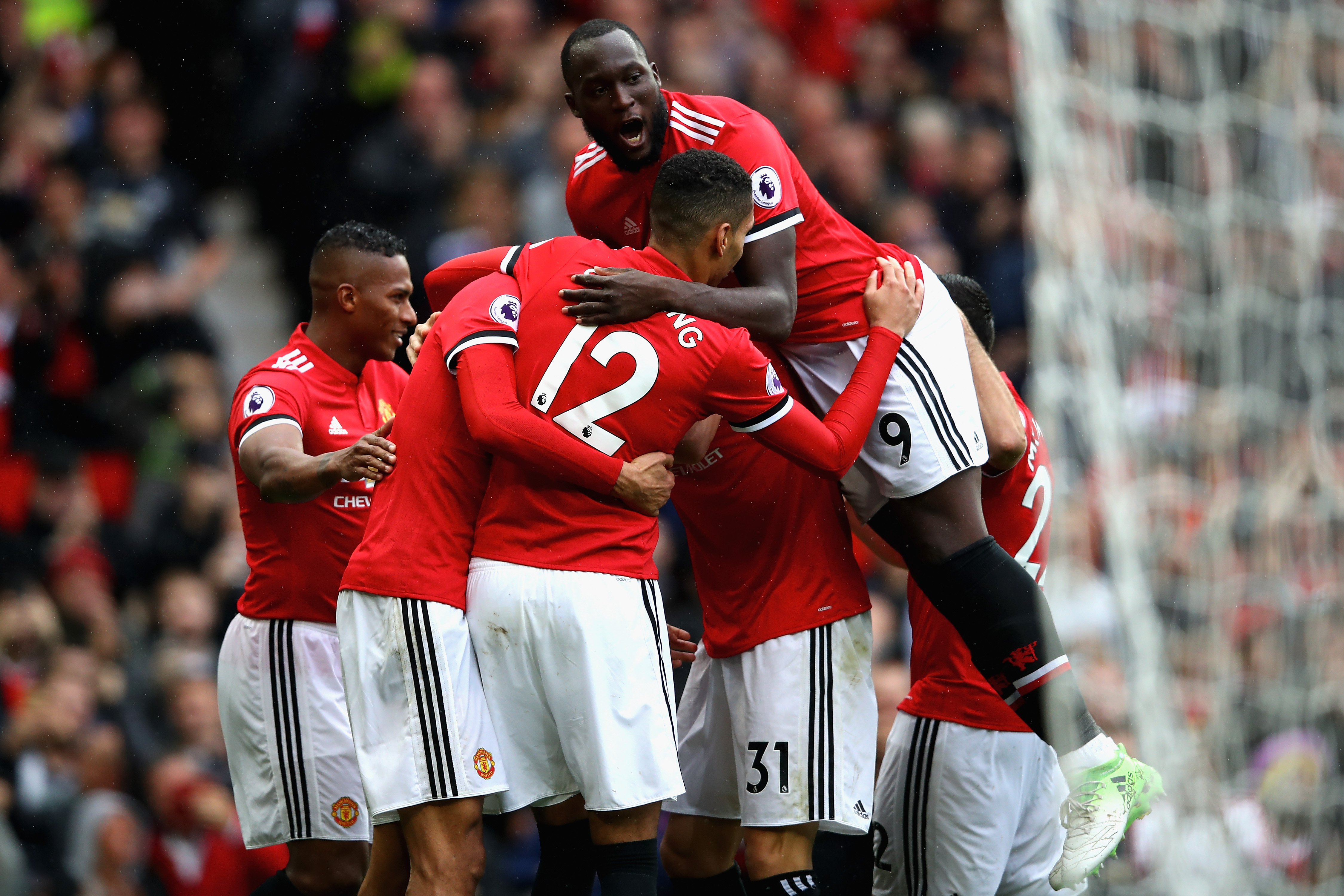 MANCHESTER, ENGLAND - SEPTEMBER 30:  Romelu Lukaku (top) of Manchester United joins the celebration as Marouane Fellaini (2nd L) of Manchester United scroing his side's third goal during the Premier League match between Manchester United and Crystal Palace at Old Trafford on September 30, 2017 in Manchester, England.  (Photo by Clive Brunskill/Getty Images)