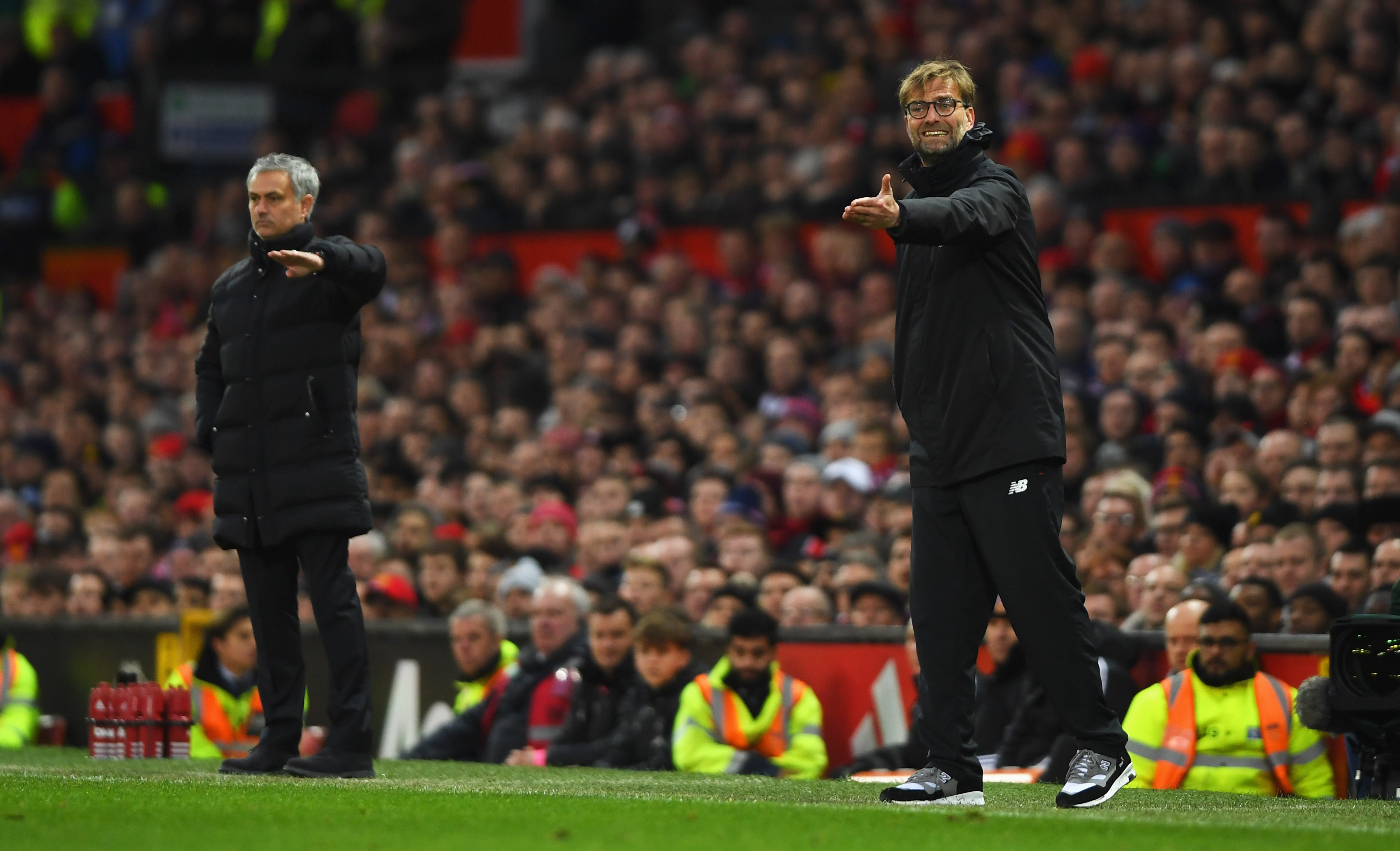 MANCHESTER, ENGLAND - JANUARY 15:  Jurgen Klopp manager of Liverpool and Jose Mourinho manager of Manchester United give instructions during the Premier League match between Manchester United and Liverpool at Old Trafford on January 15, 2017 in Manchester, England.  (Photo by Mike Hewitt/Getty Images)