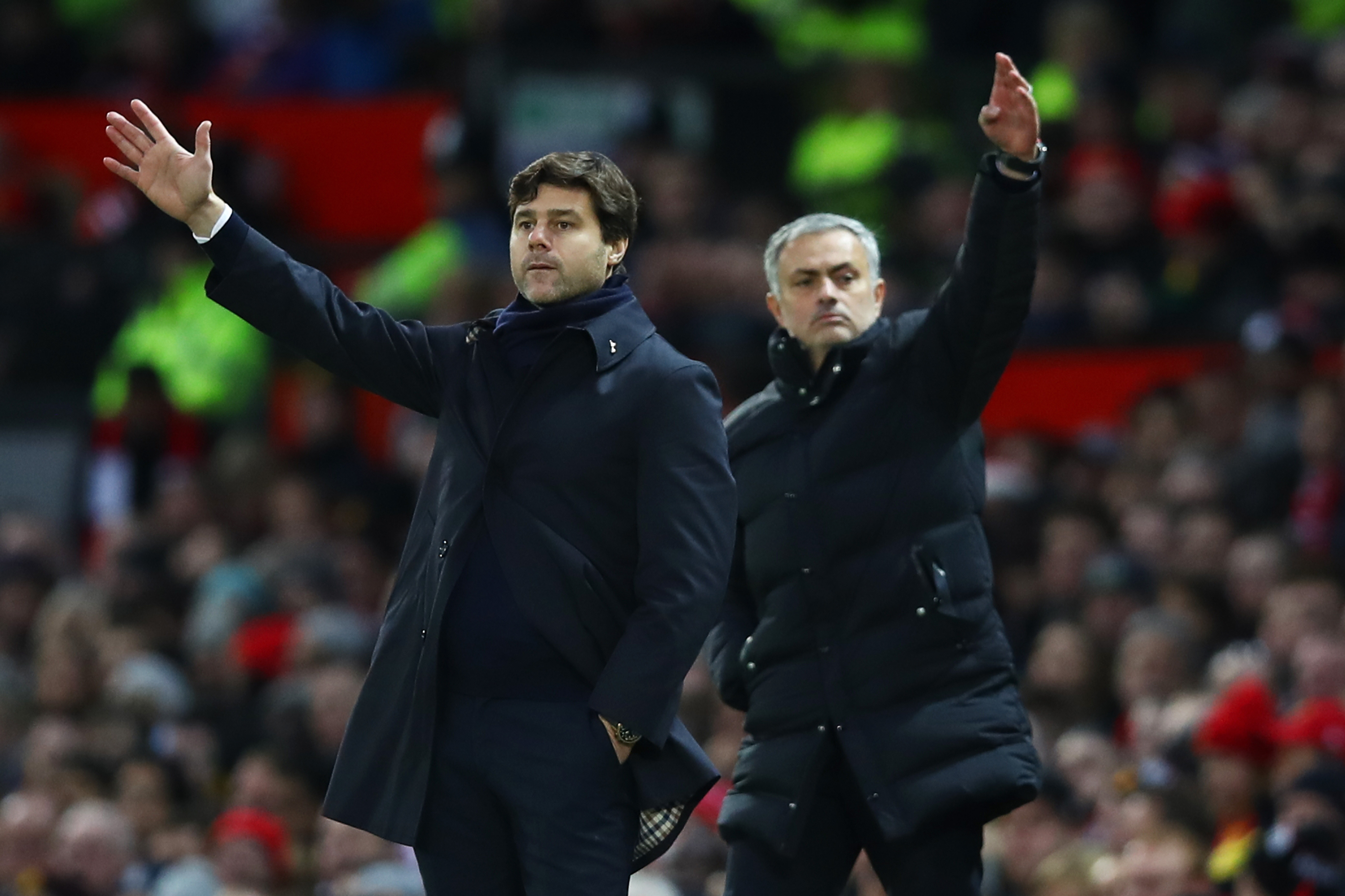 MANCHESTER, ENGLAND - DECEMBER 11: Mauricio Pochettino, Manager of Tottenham Hotspur and Jose Mourinho, Manager of Manchester United both gesture during the Premier League match between Manchester United and Tottenham Hotspur at Old Trafford on December 11, 2016 in Manchester, England.  (Photo by Clive Brunskill/Getty Images)