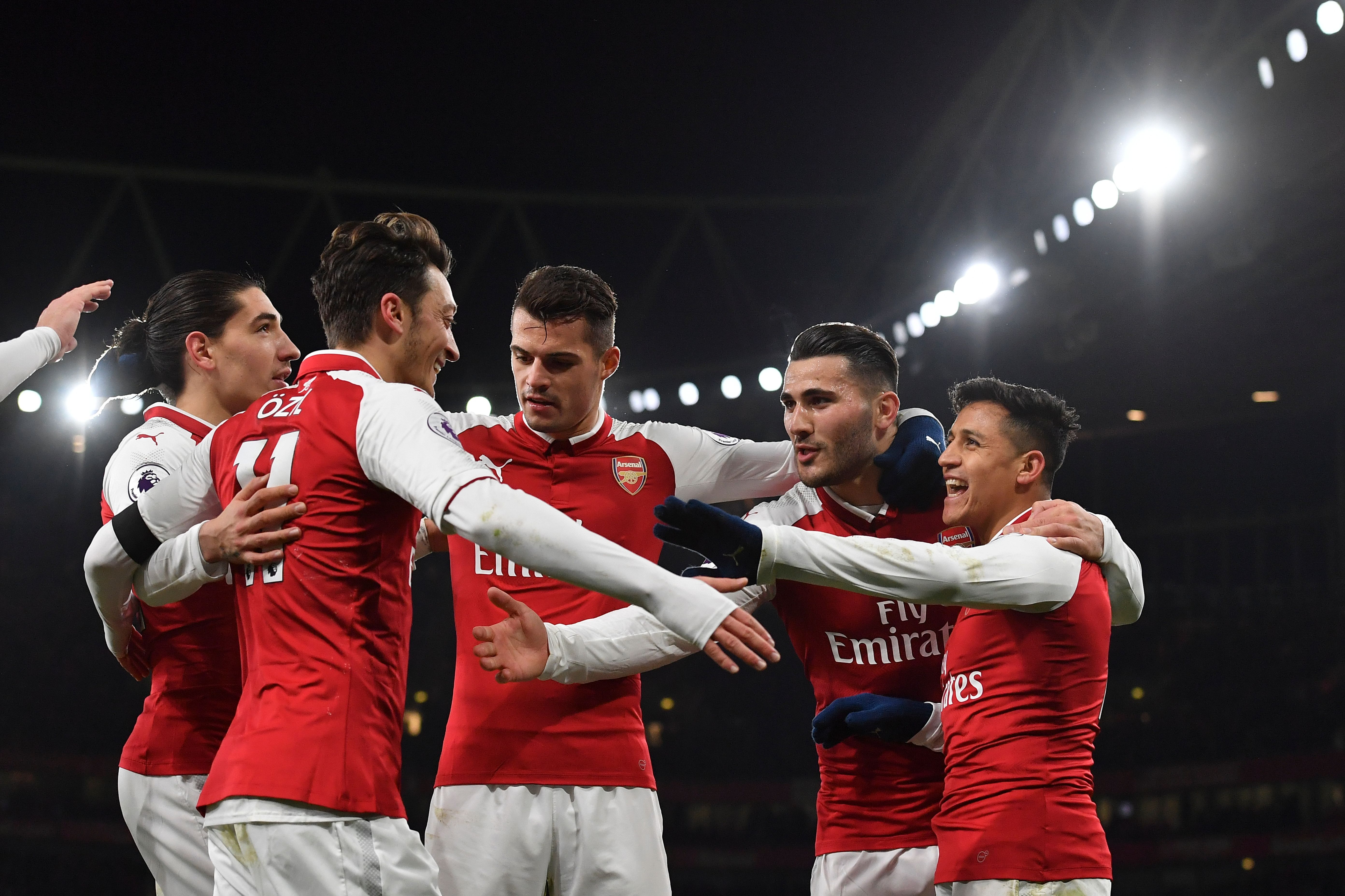 Arsenal's Chilean striker Alexis Sanchez (R) celebrates scoring their third goal during the English Premier League football match between Arsenal and Huddersfield Town at the Emirates Stadium in London on November 29, 2017.  / AFP PHOTO / Ben STANSALL / RESTRICTED TO EDITORIAL USE. No use with unauthorized audio, video, data, fixture lists, club/league logos or 'live' services. Online in-match use limited to 75 images, no video emulation. No use in betting, games or single club/league/player publications.  /         (Photo credit should read BEN STANSALL/AFP/Getty Images)