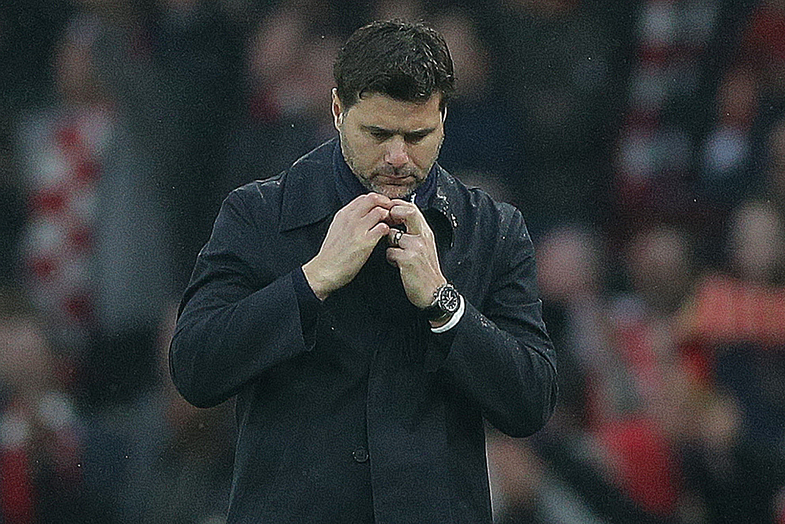 Tottenham Hotspur's Argentinian head coach Mauricio Pochettino racts following the English Premier League football match between Arsenal and Tottenham Hotspur at the Emirates Stadium in London on November 18, 2017.  / AFP PHOTO / Daniel LEAL-OLIVAS / RESTRICTED TO EDITORIAL USE. No use with unauthorized audio, video, data, fixture lists, club/league logos or 'live' services. Online in-match use limited to 75 images, no video emulation. No use in betting, games or single club/league/player publications.  /         (Photo credit should read DANIEL LEAL-OLIVAS/AFP/Getty Images)