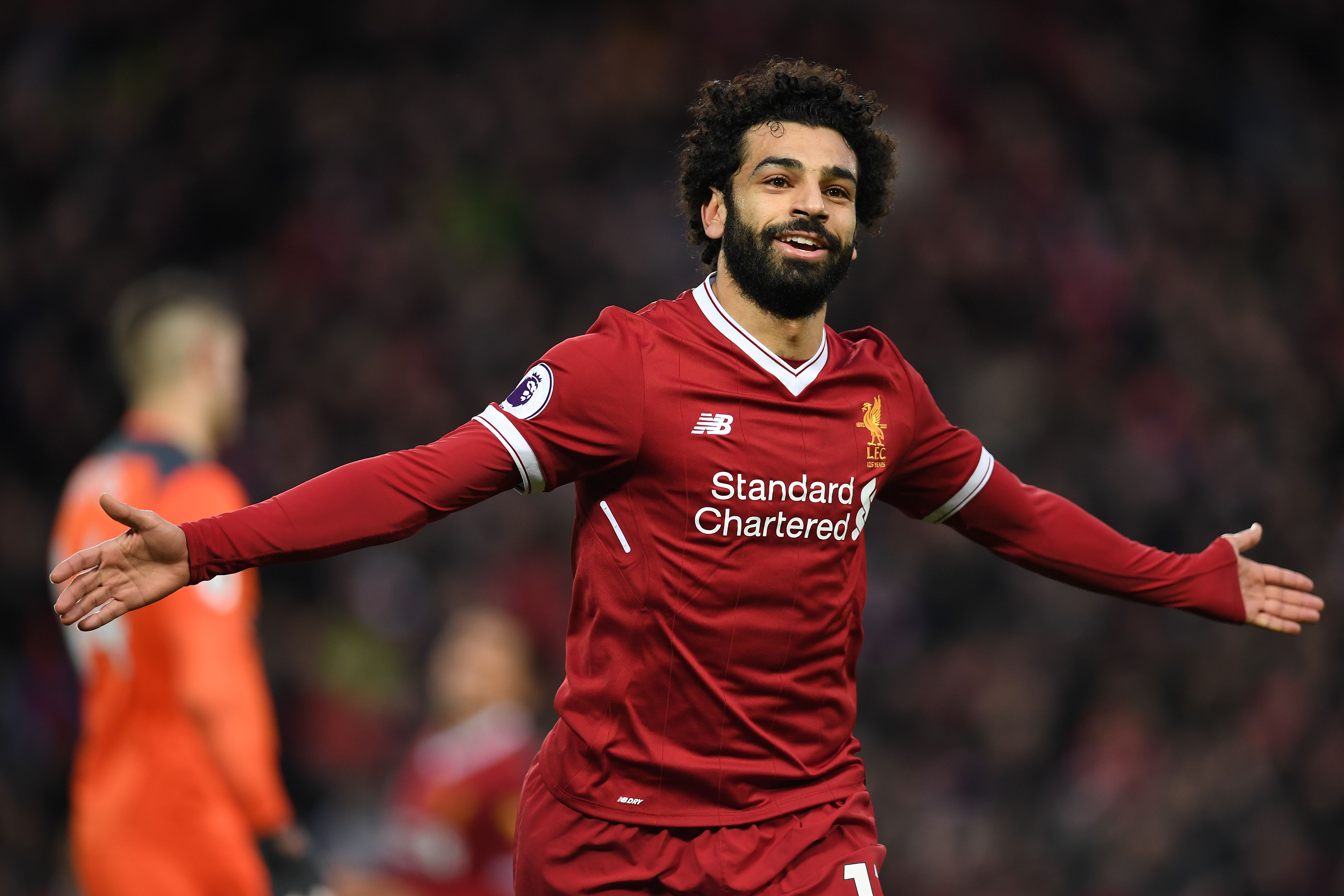 Liverpool's Egyptian midfielder Mohamed Salah celebrates scoring his team's second goal during the English Premier League football match between Liverpool and Southampton at Anfield in Liverpool, north west England on November 18, 2017. / AFP PHOTO / Paul ELLIS / RESTRICTED TO EDITORIAL USE. No use with unauthorized audio, video, data, fixture lists, club/league logos or 'live' services. Online in-match use limited to 75 images, no video emulation. No use in betting, games or single club/league/player publications.  /         (Photo credit should read PAUL ELLIS/AFP/Getty Images)