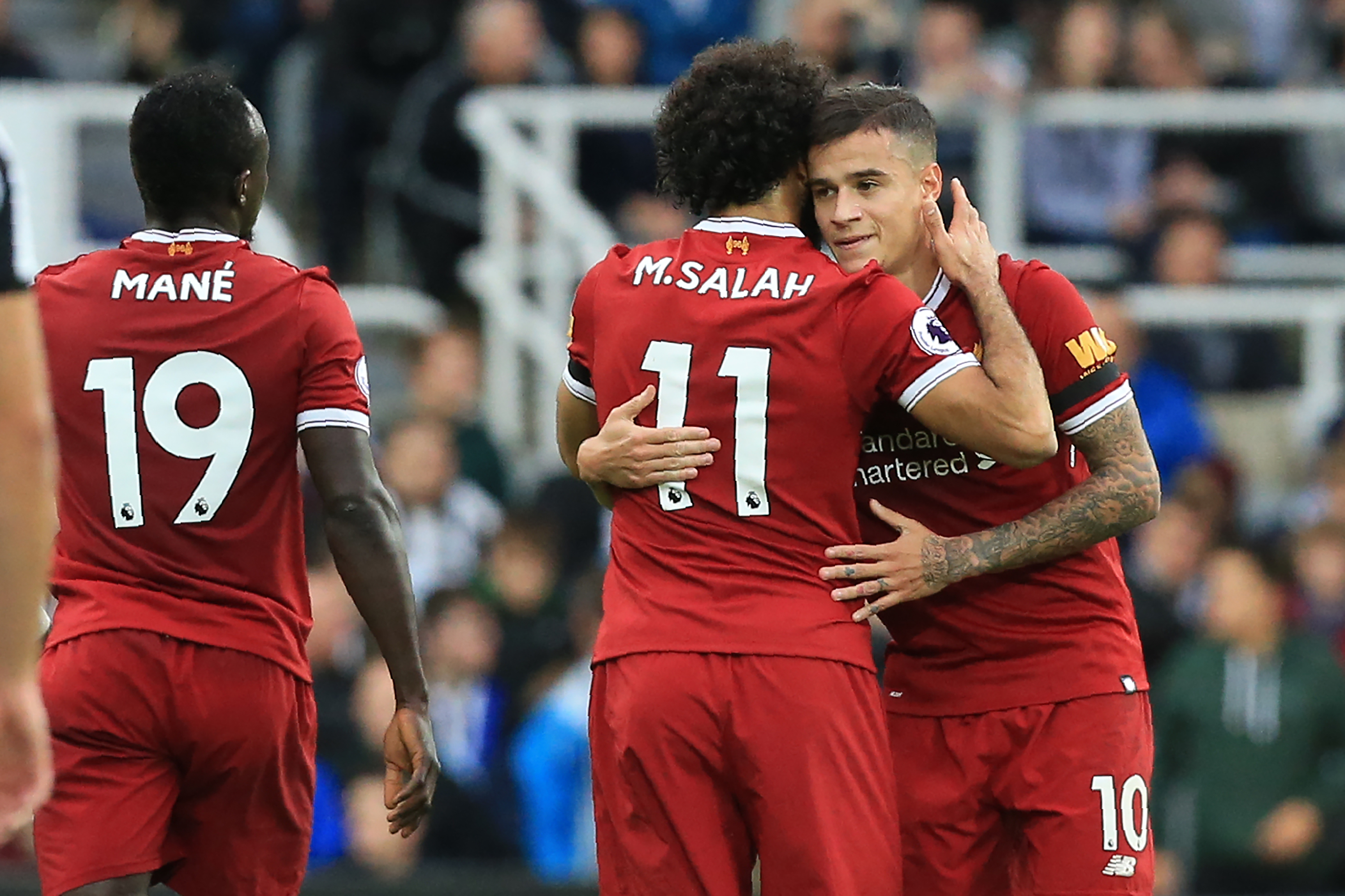 Liverpool's Brazilian midfielder Philippe Coutinho (R) celebrates with Liverpool's Egyptian midfielder Mohamed Salah after scoring the opening goal of the English Premier League football match between Newcastle United and Liverpool at St James' Park in Newcastle-upon-Tyne, north east England on October 1, 2017. / AFP PHOTO / Lindsey PARNABY / RESTRICTED TO EDITORIAL USE. No use with unauthorized audio, video, data, fixture lists, club/league logos or 'live' services. Online in-match use limited to 75 images, no video emulation. No use in betting, games or single club/league/player publications.  /         (Photo credit should read LINDSEY PARNABY/AFP/Getty Images)