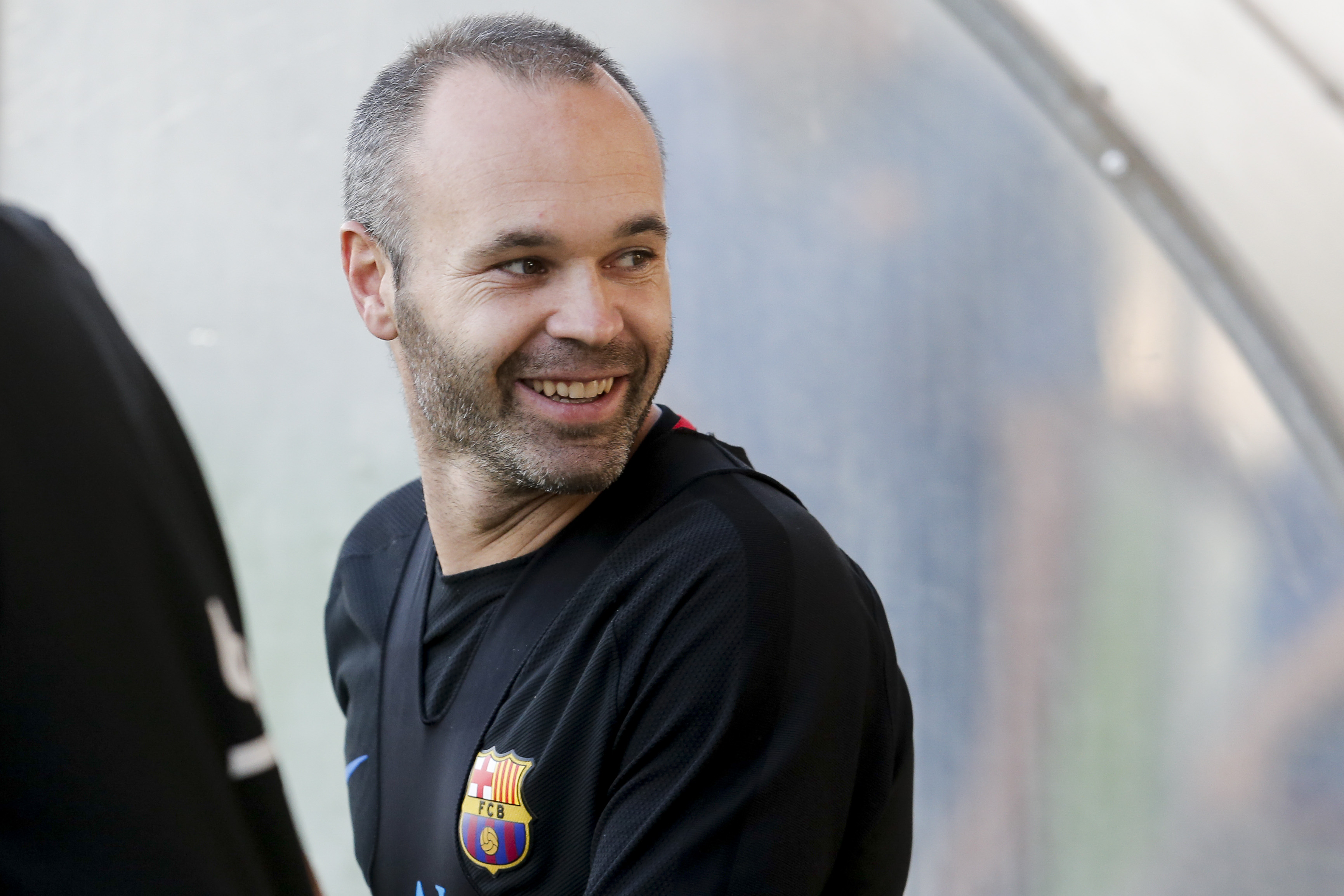 Barcelona's Spanish midfielder Andres Iniesta smiles as he arrives at a training session at the Joan Gamper Sports Center in Sant Joan Despi, near Barcelona on October 13, 2017, on the eve of a Spanish League football match against Club Atletico de Madrid. / AFP PHOTO / PAU BARRENA        (Photo credit should read PAU BARRENA/AFP/Getty Images)