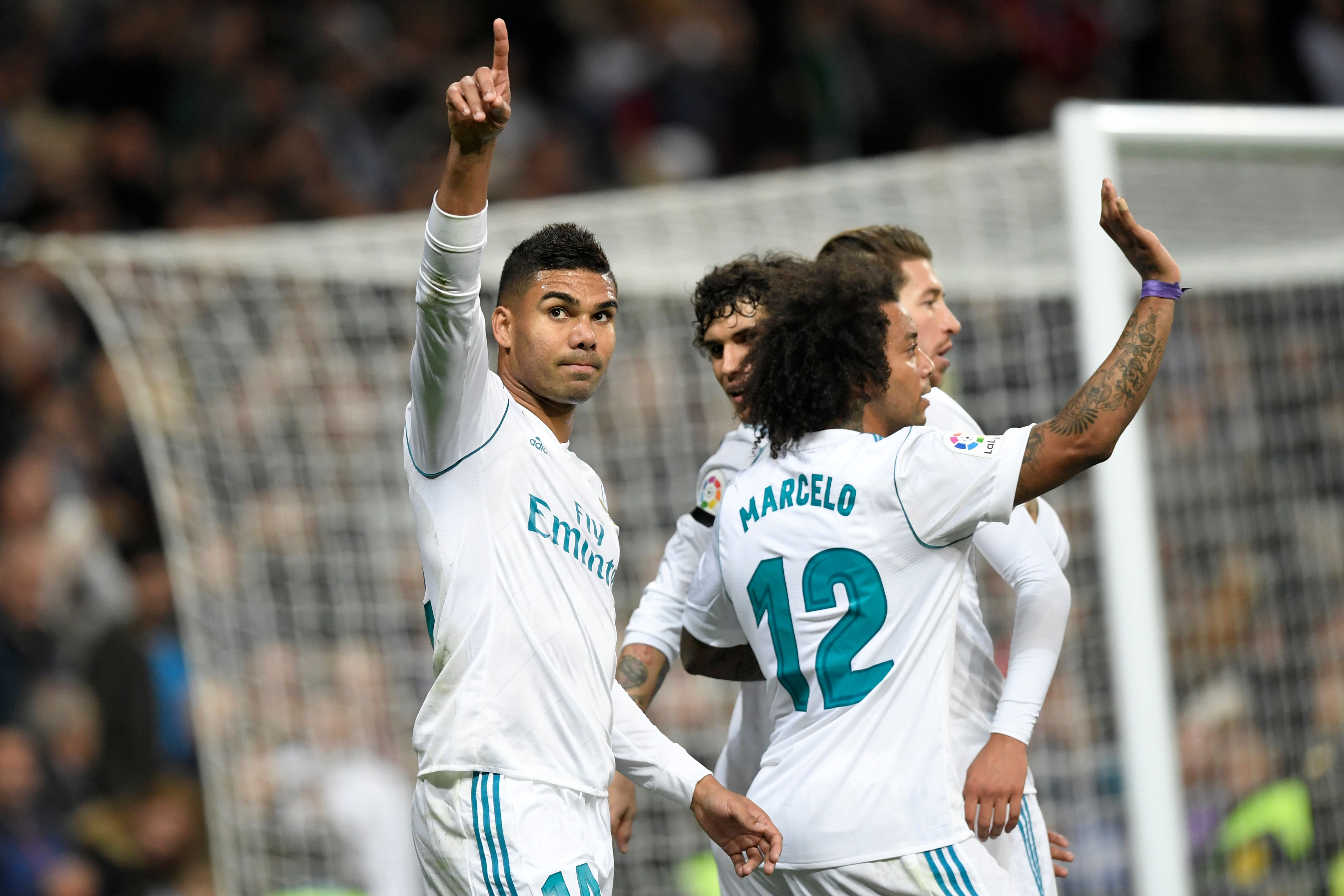 Real Madrid's Brazilian midfielder Casemiro (L) celebrates with teammates after scoring a goal during the Spanish league football match Real Madrid CF vs UD Las Palmas at the Santiago Bernabeu stadium in Madrid on November 5, 2017. / AFP PHOTO / GABRIEL BOUYS        (Photo credit should read GABRIEL BOUYS/AFP/Getty Images)