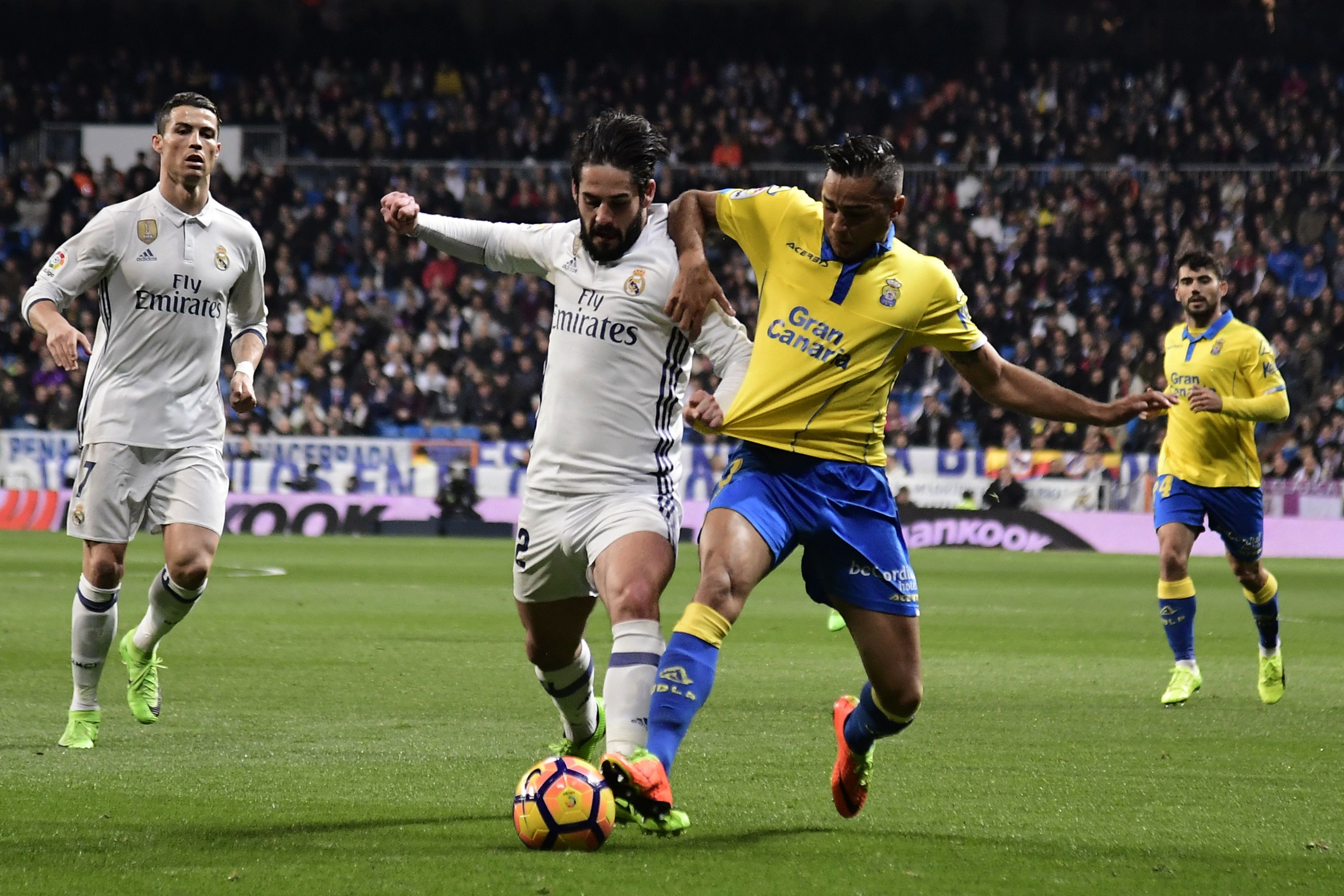 Real Madrid's midfielder Isco (2ndL) vies with Las Palmas' defender David Simon during the Spanish league football match Real Madrid CF vs UD Las Palmas at the Santiago Bernabeu stadium in Madrid on March 1, 2017. / AFP PHOTO / JAVIER SORIANO        (Photo credit should read JAVIER SORIANO/AFP/Getty Images)