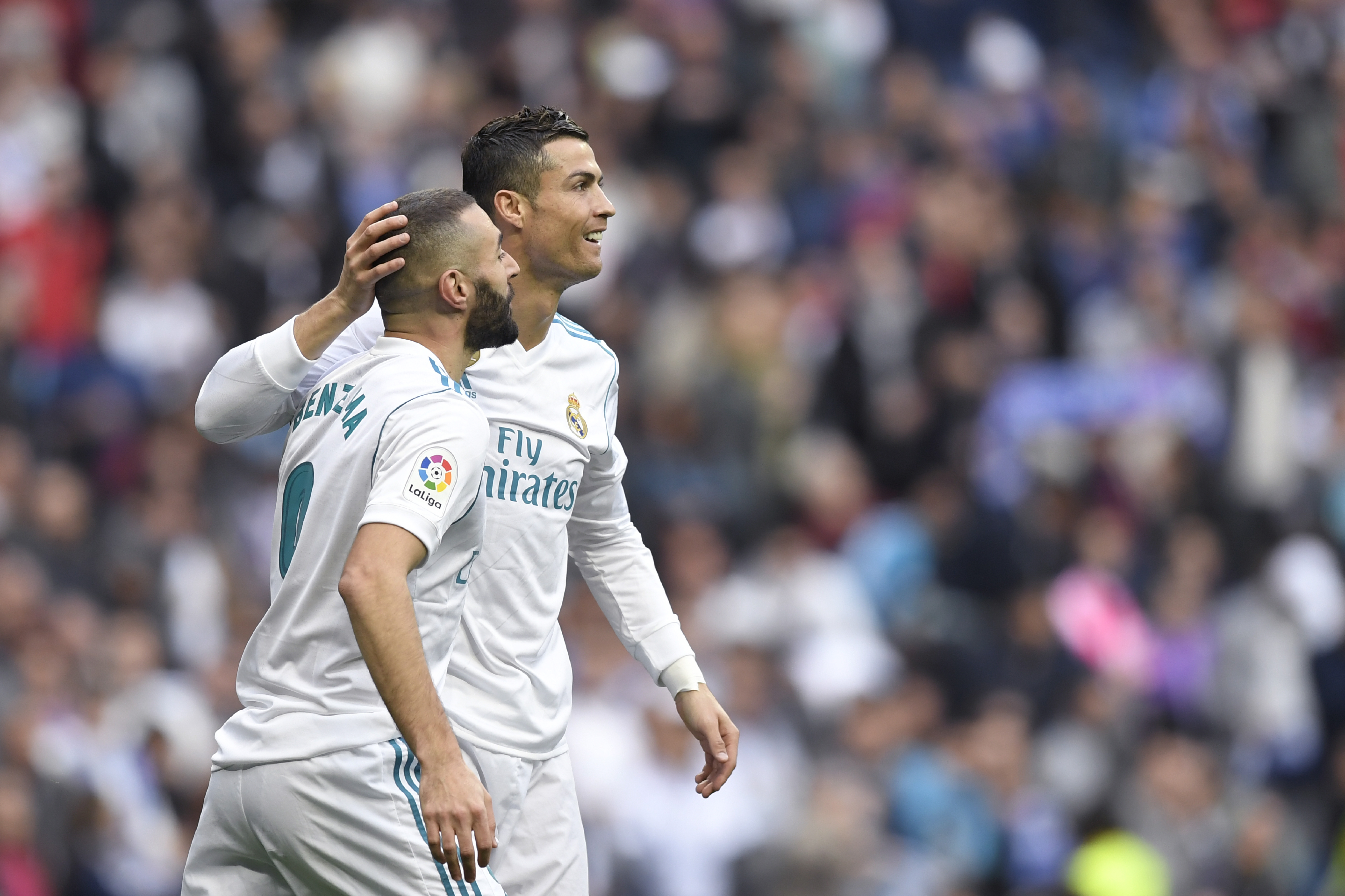Real Madrid's French forward Karim Benzema (L) celebrates with Real Madrid's Portuguese forward Cristiano Ronaldo  after scoring during the Spanish league football match Real Madrid CF against Malaga CF on 25, November 2017 at the Santiago Bernabeu stadium in Madrid. / AFP PHOTO / GABRIEL BOUYS        (Photo credit should read GABRIEL BOUYS/AFP/Getty Images)
