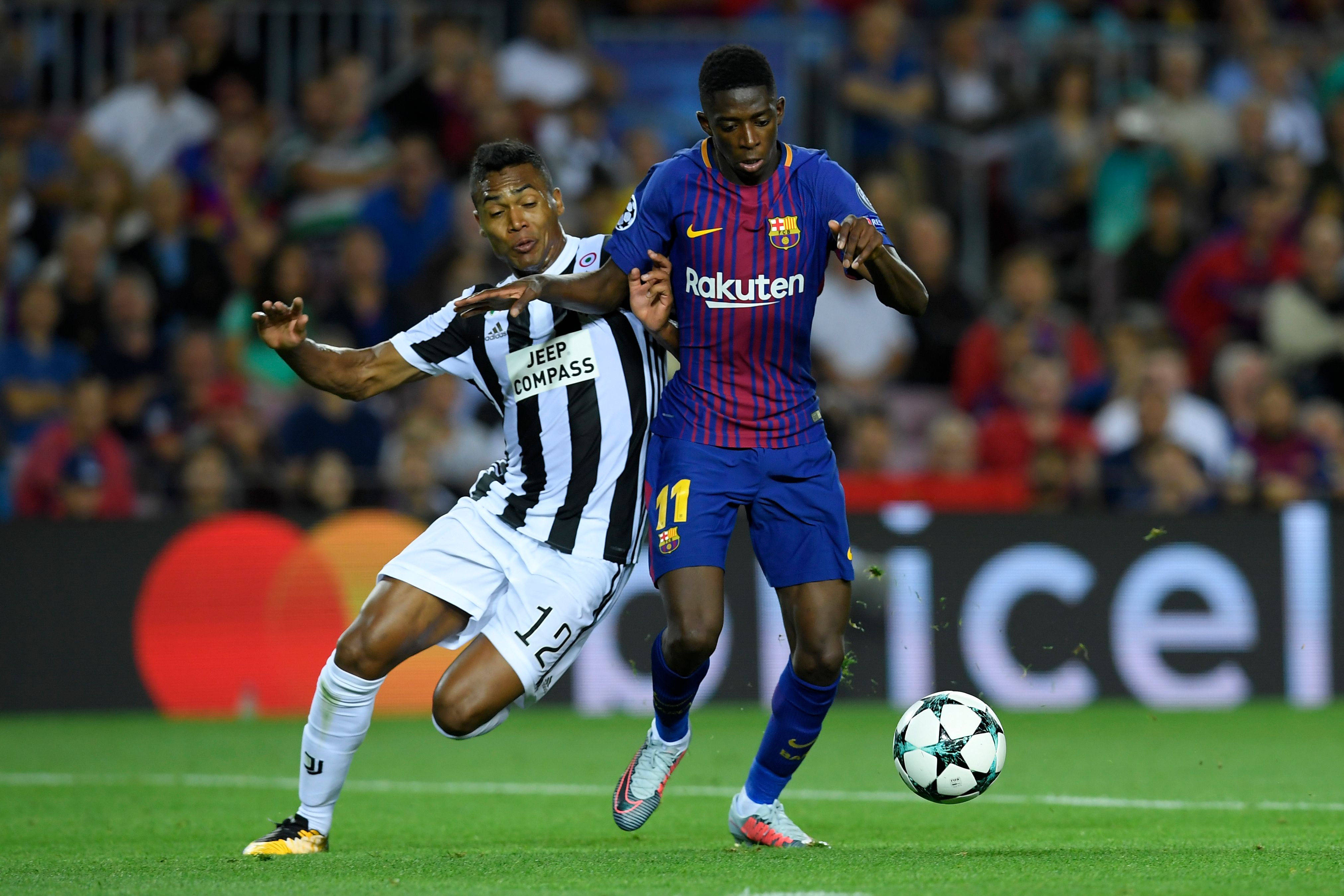 Juventus' defender from Brazil Alex Sandro (L) vies with Barcelona's forward from France Ousmane Dembele during the UEFA Champions League Group D football match FC Barcelona vs Juventus at the Camp Nou stadium in Barcelona on September 12, 2017. / AFP PHOTO / LLUIS GENE        (Photo credit should read LLUIS GENE/AFP/Getty Images)