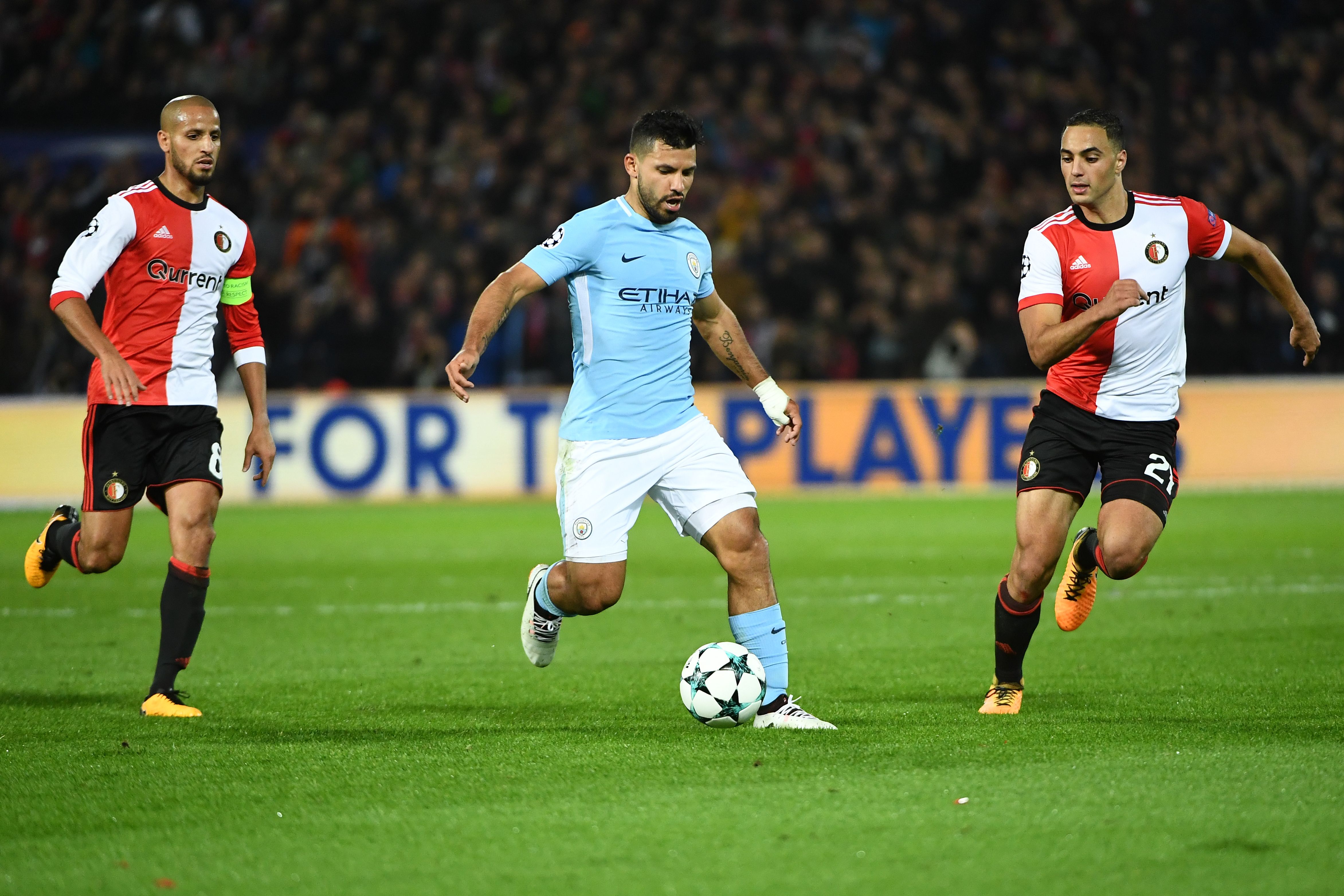 Manchester City's Argentinian striker Sergio Aguero (C) vies for the ball with Feyenoord's Moroccan midfielder Sofyan Amrabat (R)  during the UEFA Champions League Group F football match between Feyenoord Rotterdam and Manchester City at the Feyenoord Stadium in Rotterdam, on September 13, 2017. / AFP PHOTO / Emmanuel DUNAND        (Photo credit should read EMMANUEL DUNAND/AFP/Getty Images)
