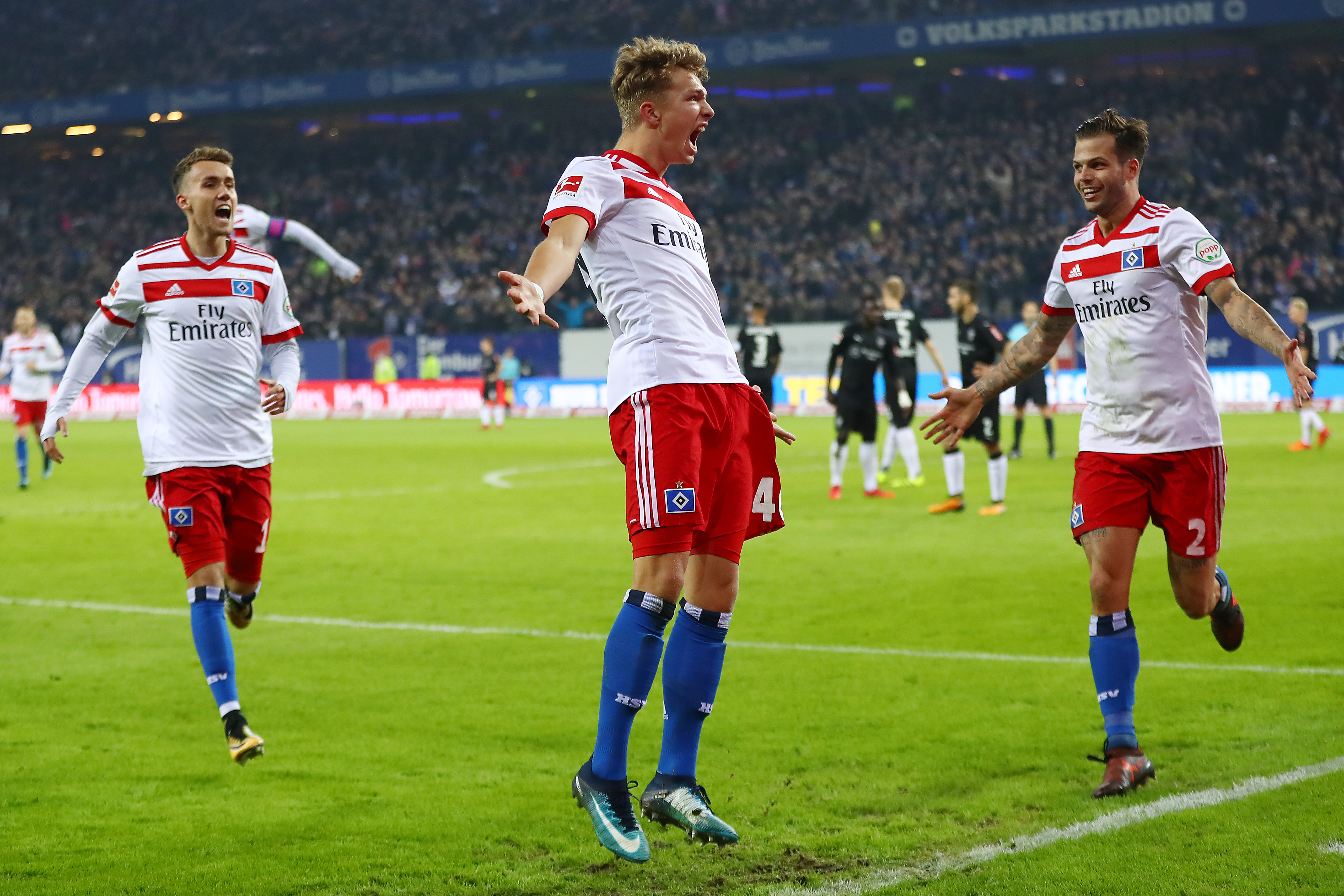 HAMBURG, GERMANY - NOVEMBER 04: Jann-Fiete Arp of Hamburg (c) celebrates after he scored a goal to make it 3:1 during the Bundesliga match between Hamburger SV and VfB Stuttgart at Volksparkstadion on November 4, 2017 in Hamburg, Germany. (Photo by Martin Rose/Bongarts/Getty Images)