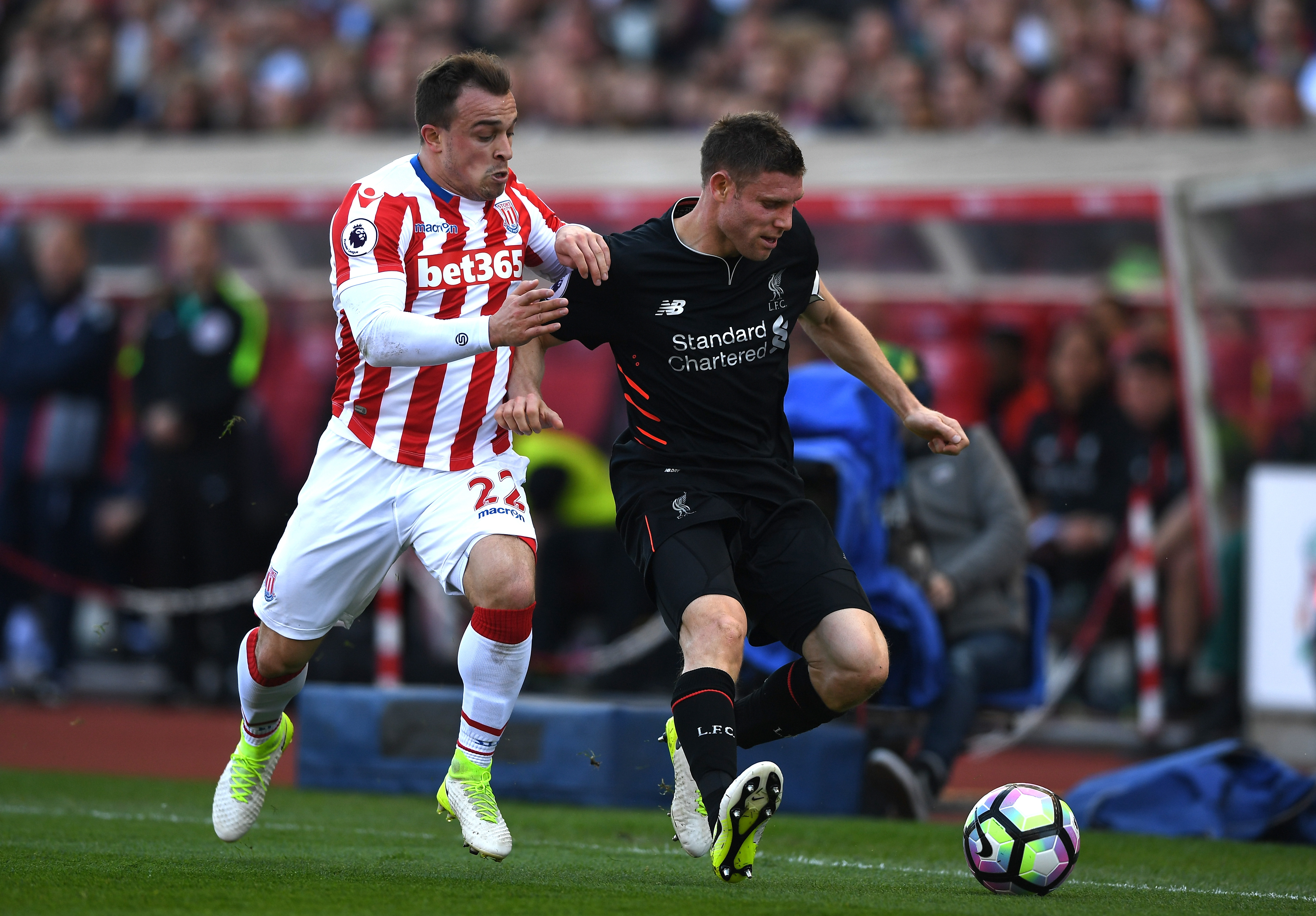 STOKE ON TRENT, ENGLAND - APRIL 08: Xherdan Shaqiri of Stoke City (L) and James Milner of Liverpool (R) battle for possession during the Premier League match between Stoke City and Liverpool at Bet365 Stadium on April 8, 2017 in Stoke on Trent, England.  (Photo by Gareth Copley/Getty Images)