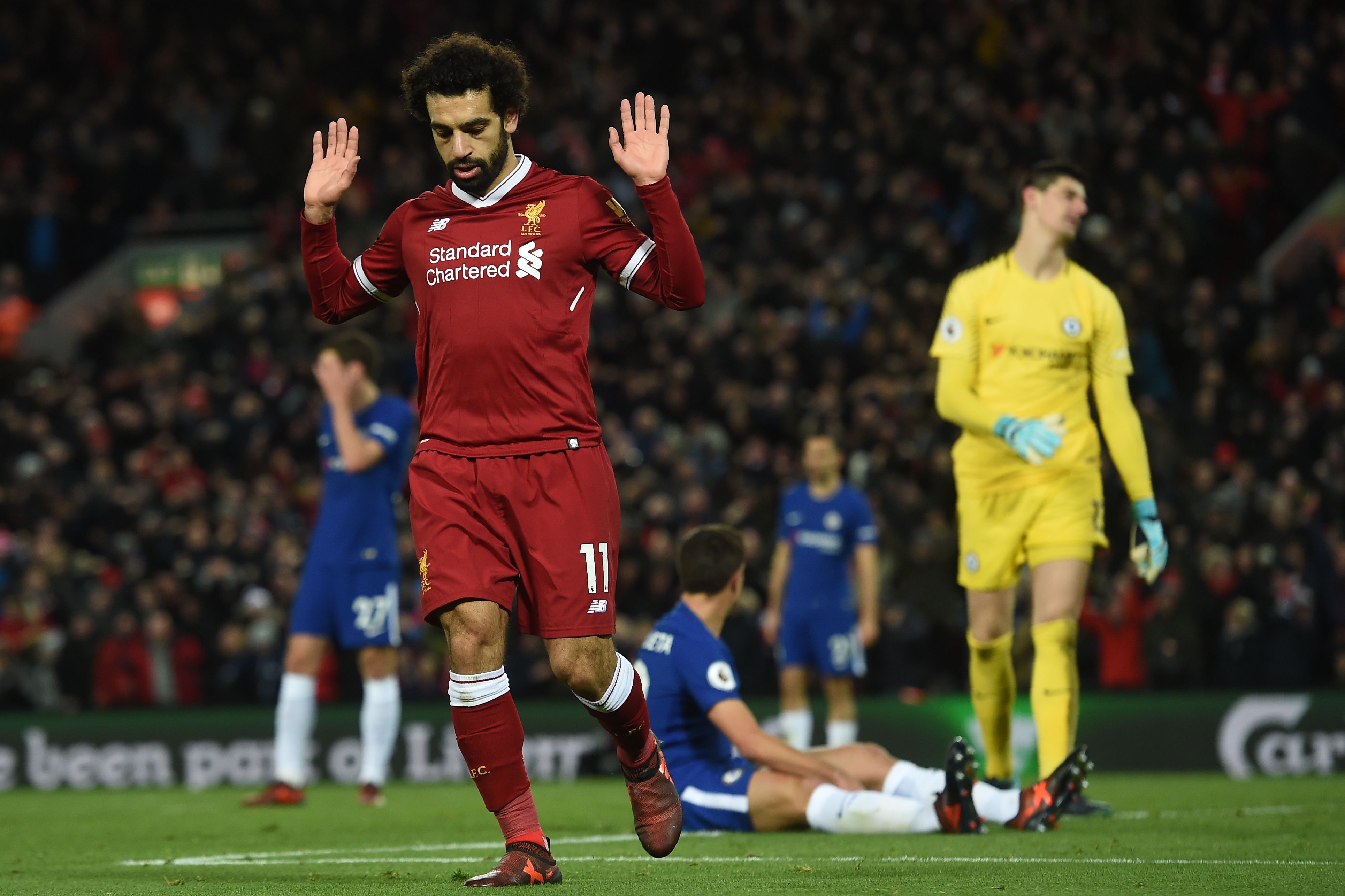 Liverpool's Egyptian midfielder Mohamed Salah (L) reacts after scoring the opening goal of the English Premier League football match between Liverpool and  Chelsea at Anfield in Liverpool, north west England on November 25, 2017.
The game finished 1-1. / AFP PHOTO / Paul ELLIS / RESTRICTED TO EDITORIAL USE. No use with unauthorized audio, video, data, fixture lists, club/league logos or 'live' services. Online in-match use limited to 75 images, no video emulation. No use in betting, games or single club/league/player publications.  /         (Photo credit should read PAUL ELLIS/AFP/Getty Images)