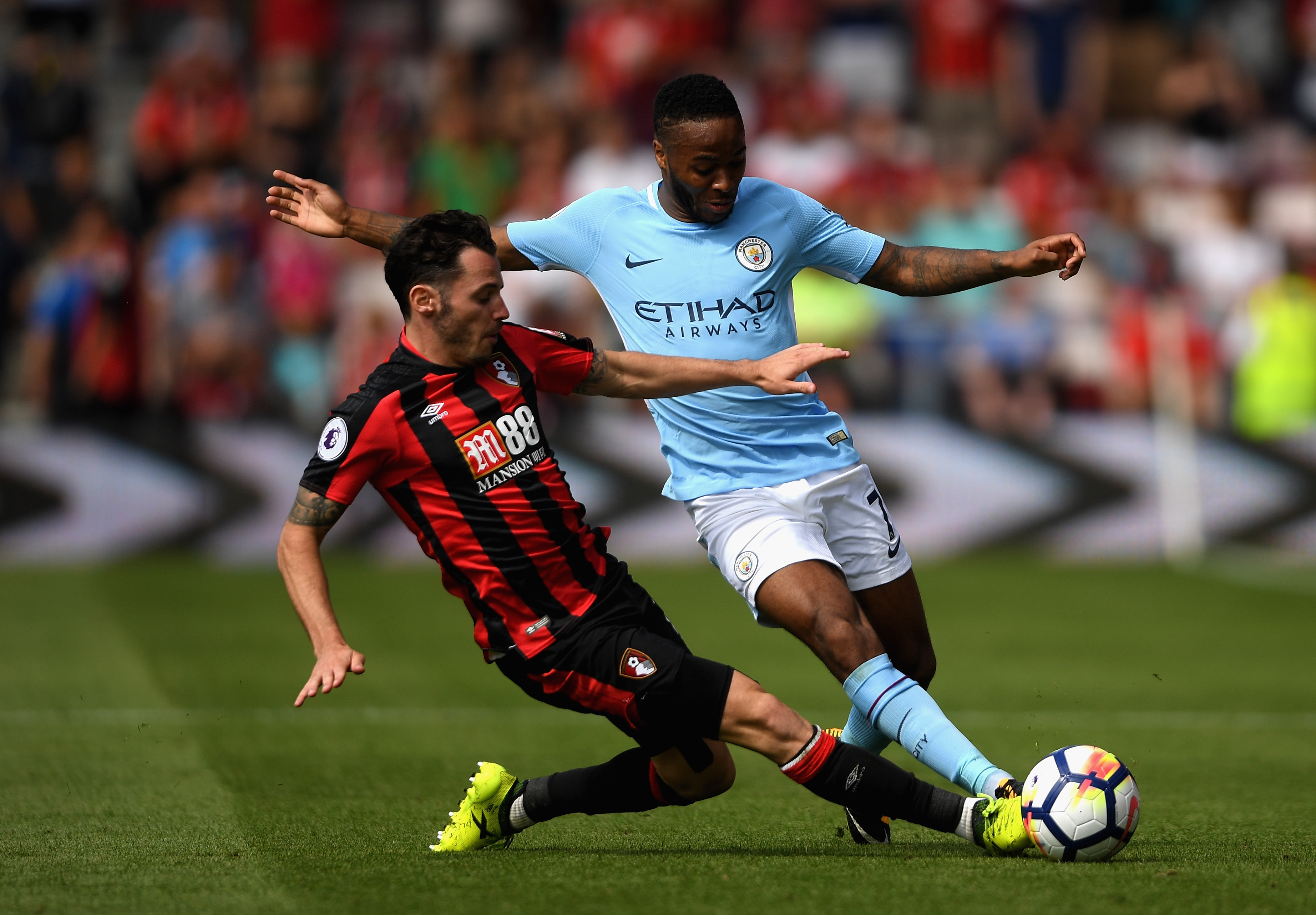 BOURNEMOUTH, ENGLAND - AUGUST 26:  Adam Smith of AFC Bournemouth and Raheem Sterling of Manchester City battle for possession during the Premier League match between AFC Bournemouth and Manchester City at Vitality Stadium on August 26, 2017 in Bournemouth, England.  (Photo by Mike Hewitt/Getty Images)