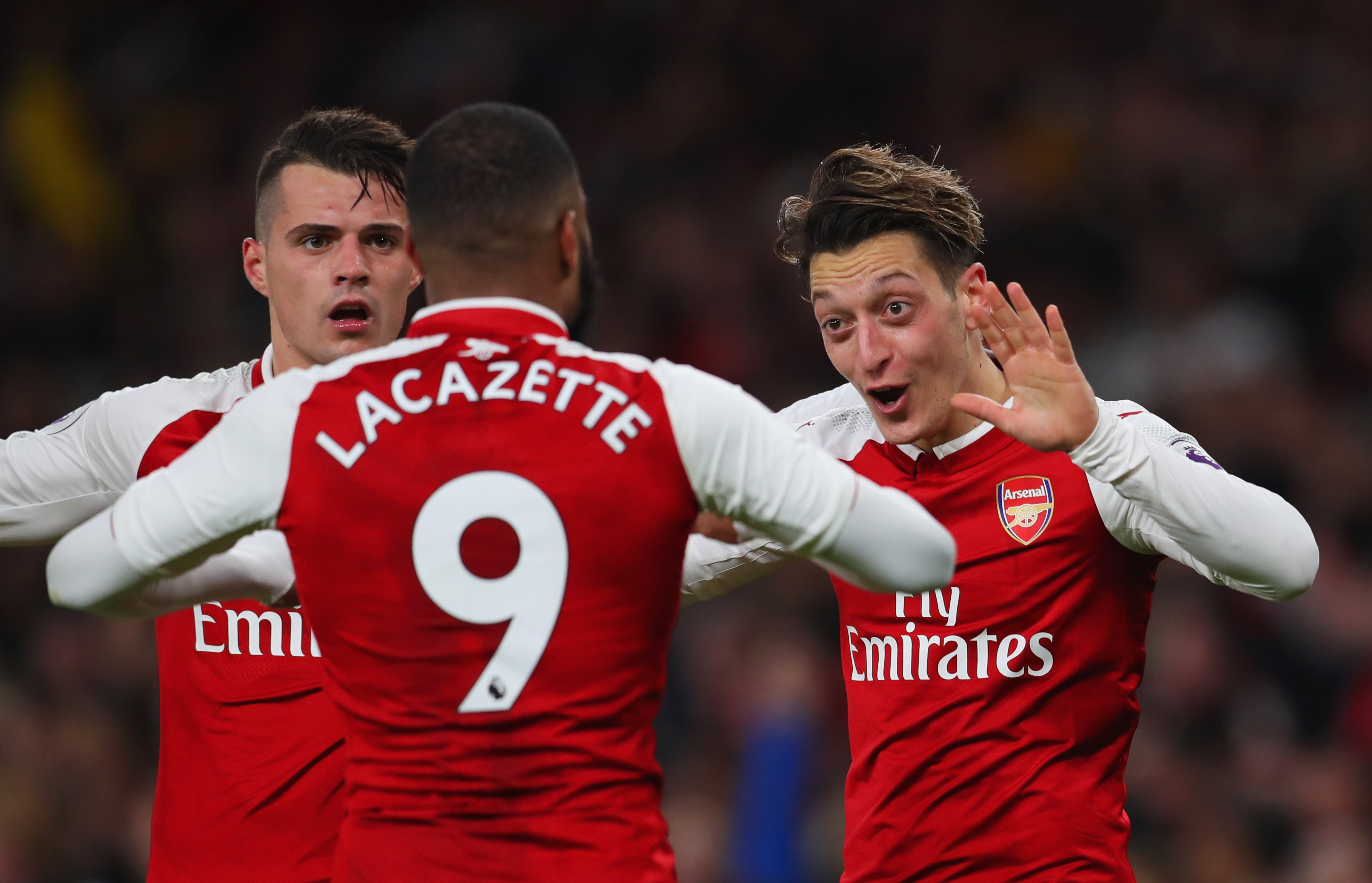 LONDON, ENGLAND - DECEMBER 22:  Mesut Ozil of Arsenal (R) celebrates as he scores their third goal with Granit Xhaka and Alexandre Lacazette during the Premier League match between Arsenal and Liverpool at Emirates Stadium on December 22, 2017 in London, England.  (Photo by Catherine Ivill/Getty Images)