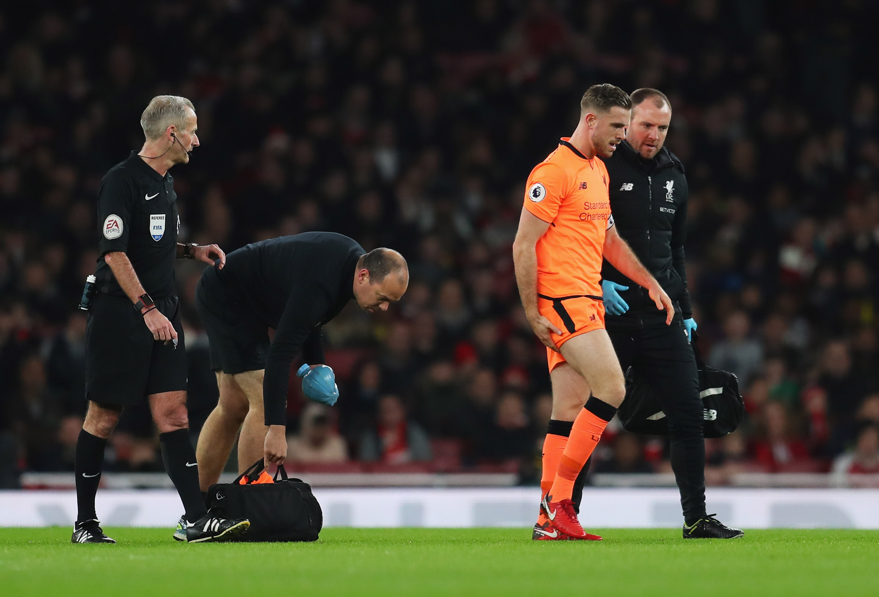 LONDON, ENGLAND - DECEMBER 22:  An injured Jordan Henderson of Liverpool (14) is given assistance during the Premier League match between Arsenal and Liverpool at Emirates Stadium on December 22, 2017 in London, England.  (Photo by Catherine Ivill/Getty Images)