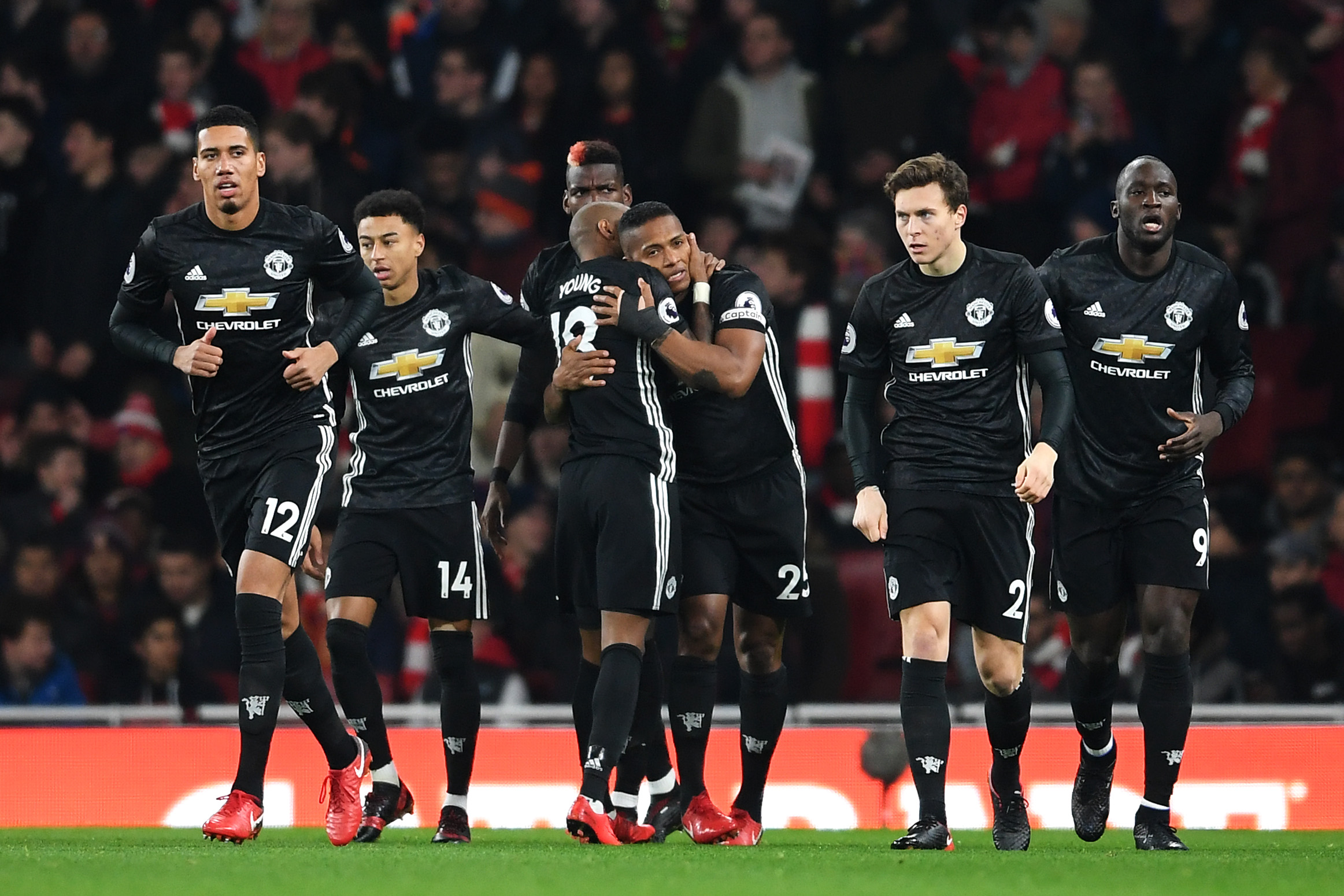 LONDON, ENGLAND - DECEMBER 02: Antonio Valencia of Manchester United celebrates after scoring his sides first goal with Ashley Young of Manchester United during the Premier League match between Arsenal and Manchester United at Emirates Stadium on December 2, 2017 in London, England.  (Photo by Laurence Griffiths/Getty Images)