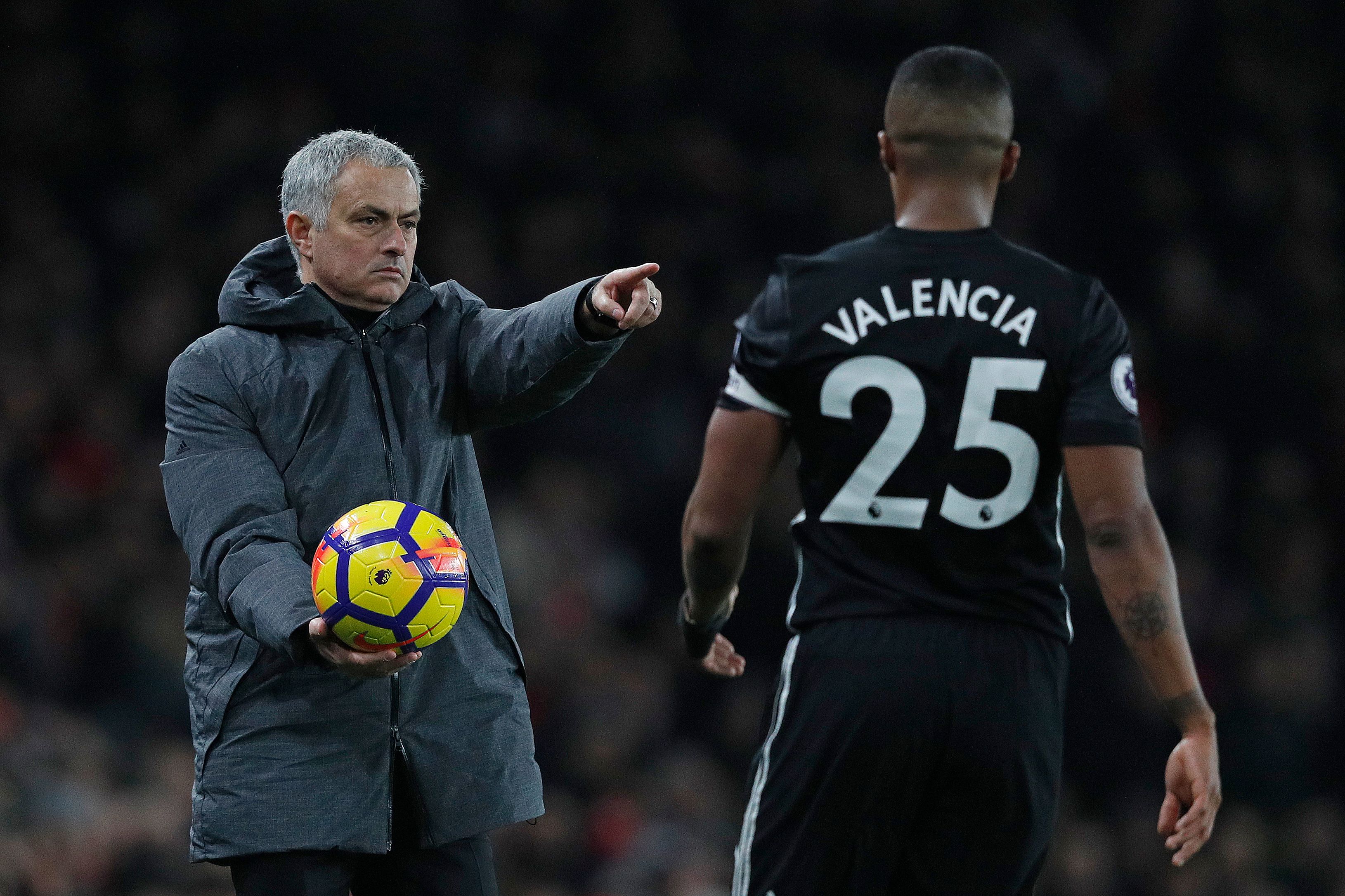 Manchester United's Portuguese manager Jose Mourinho (L) gestures as he gives the ball to Manchester United's Ecuadorian midfielder Antonio Valencia during the English Premier League football match between Arsenal and Manchester United at the Emirates Stadium in London on December 2, 2017.  / AFP PHOTO / Adrian DENNIS / RESTRICTED TO EDITORIAL USE. No use with unauthorized audio, video, data, fixture lists, club/league logos or 'live' services. Online in-match use limited to 75 images, no video emulation. No use in betting, games or single club/league/player publications.  /         (Photo credit should read ADRIAN DENNIS/AFP/Getty Images)