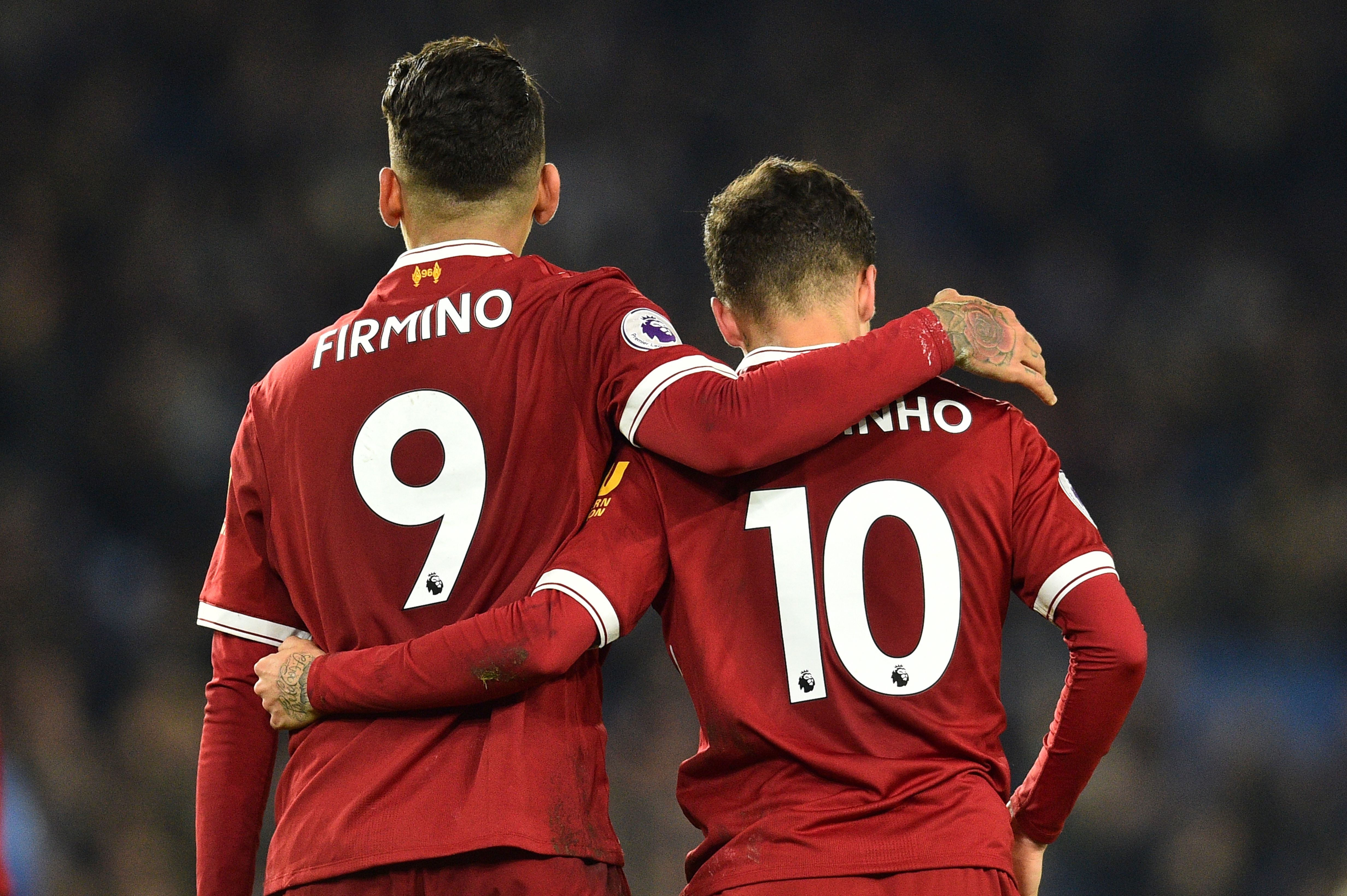 Liverpool's Brazilian midfielder Roberto Firmino (L) and Liverpool's Brazilian midfielder Philippe Coutinho (R) walk with arms around each other during the English Premier League football match between Brighton and Hove Albion and Liverpool at the American Express Community Stadium in Brighton, southern England on December 2, 2017. / AFP PHOTO / Glyn KIRK / RESTRICTED TO EDITORIAL USE. No use with unauthorized audio, video, data, fixture lists, club/league logos or 'live' services. Online in-match use limited to 75 images, no video emulation. No use in betting, games or single club/league/player publications.  /         (Photo credit should read GLYN KIRK/AFP/Getty Images)