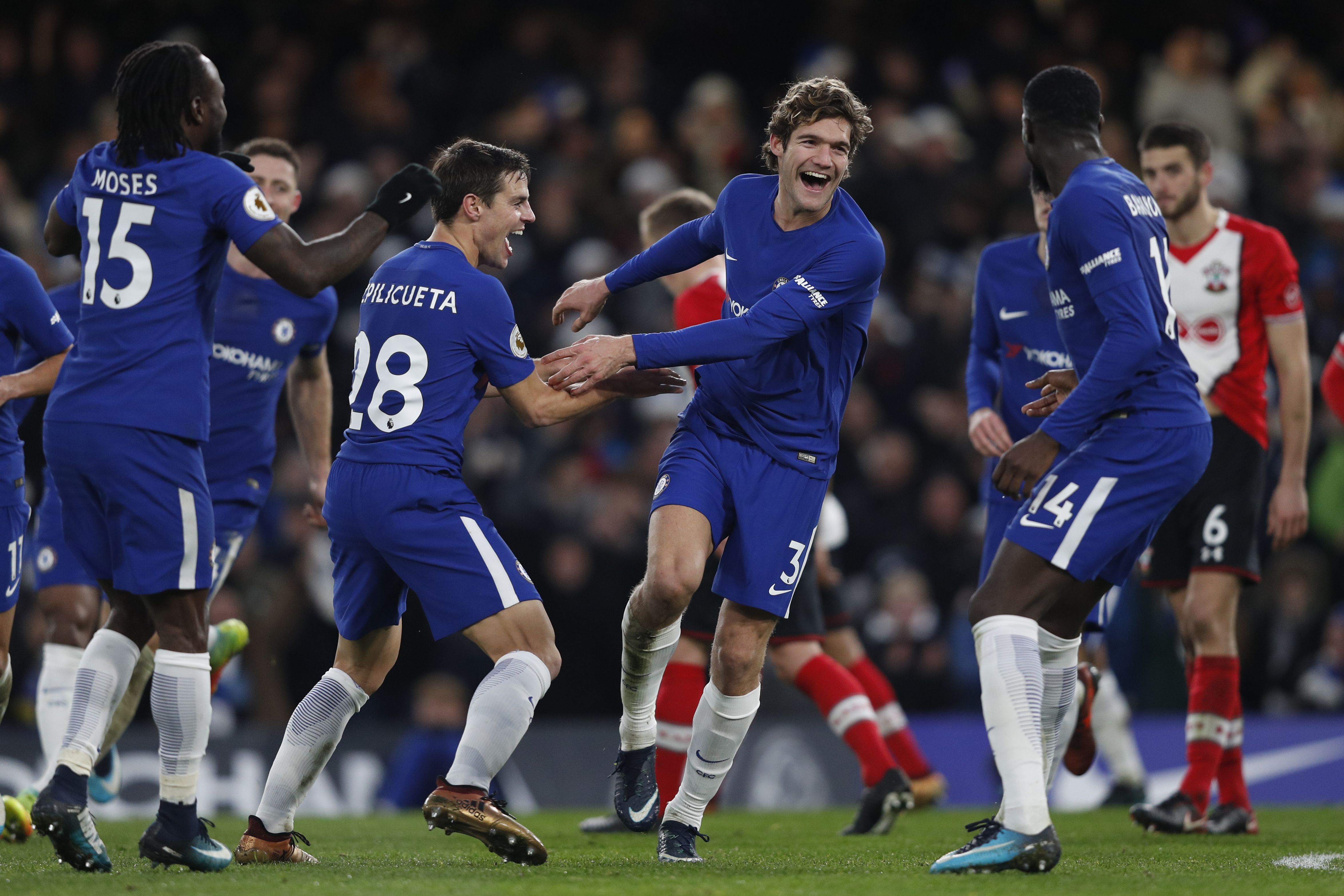 Chelsea's Spanish defender Marcos Alonso (C) celebrates after scoring with Chelsea's French midfielder Tiemoue Bakayoko (R) and Chelsea's Spanish defender Cesar Azpilicueta during the English Premier League football match between Chelsea and Southampton at Stamford Bridge in London on December 16, 2017. / AFP PHOTO / Adrian DENNIS / RESTRICTED TO EDITORIAL USE. No use with unauthorized audio, video, data, fixture lists, club/league logos or 'live' services. Online in-match use limited to 75 images, no video emulation. No use in betting, games or single club/league/player publications.  /         (Photo credit should read ADRIAN DENNIS/AFP/Getty Images)