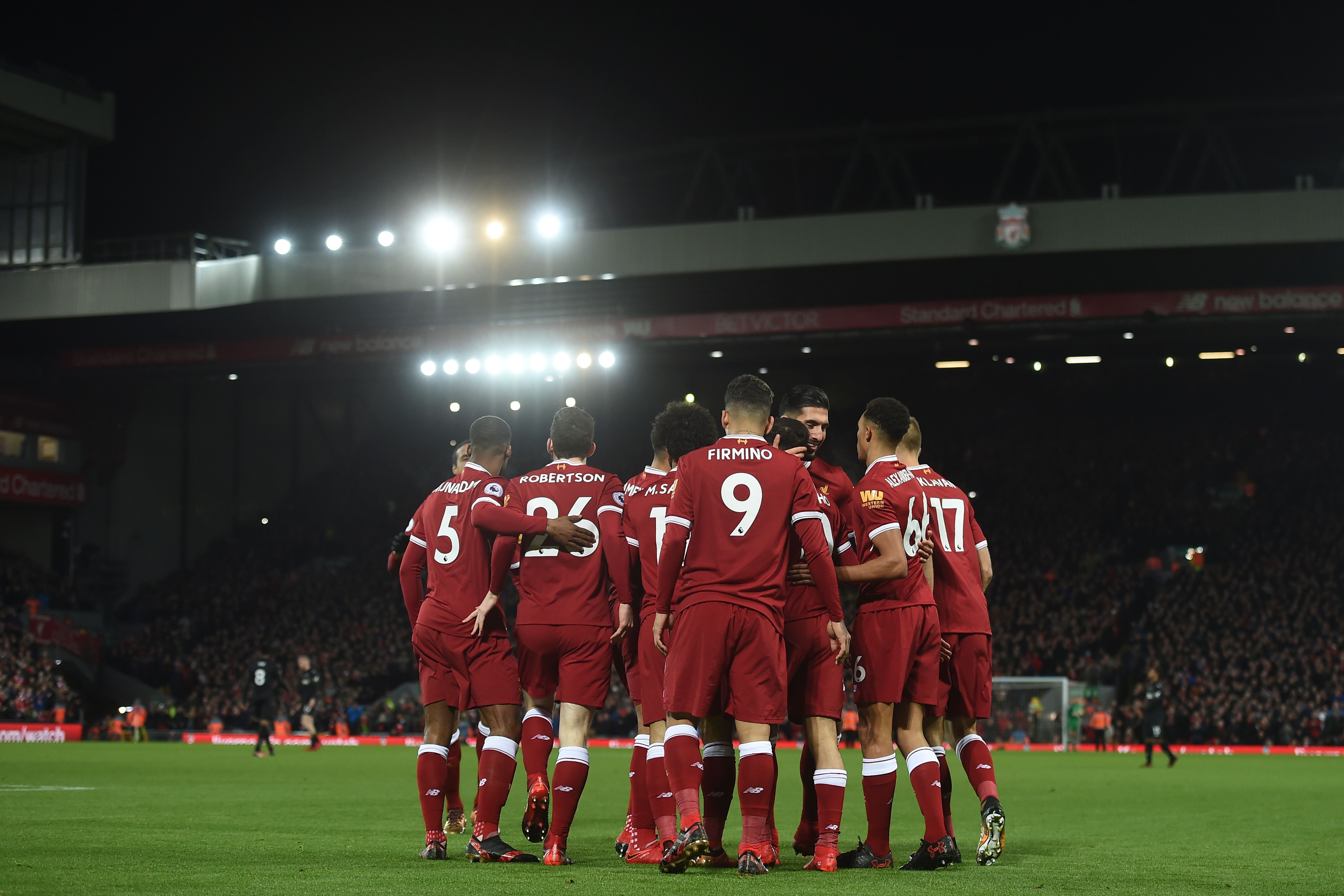Liverpool players celebrate after their first goal scored by Liverpool's Brazilian midfielder Philippe Coutinho during the English Premier League football match between Liverpool and Swansea City at Anfield in Liverpool, north west England on December 26, 2017. / AFP PHOTO / PAUL ELLIS / RESTRICTED TO EDITORIAL USE. No use with unauthorized audio, video, data, fixture lists, club/league logos or 'live' services. Online in-match use limited to 75 images, no video emulation. No use in betting, games or single club/league/player publications.  /         (Photo credit should read PAUL ELLIS/AFP/Getty Images)