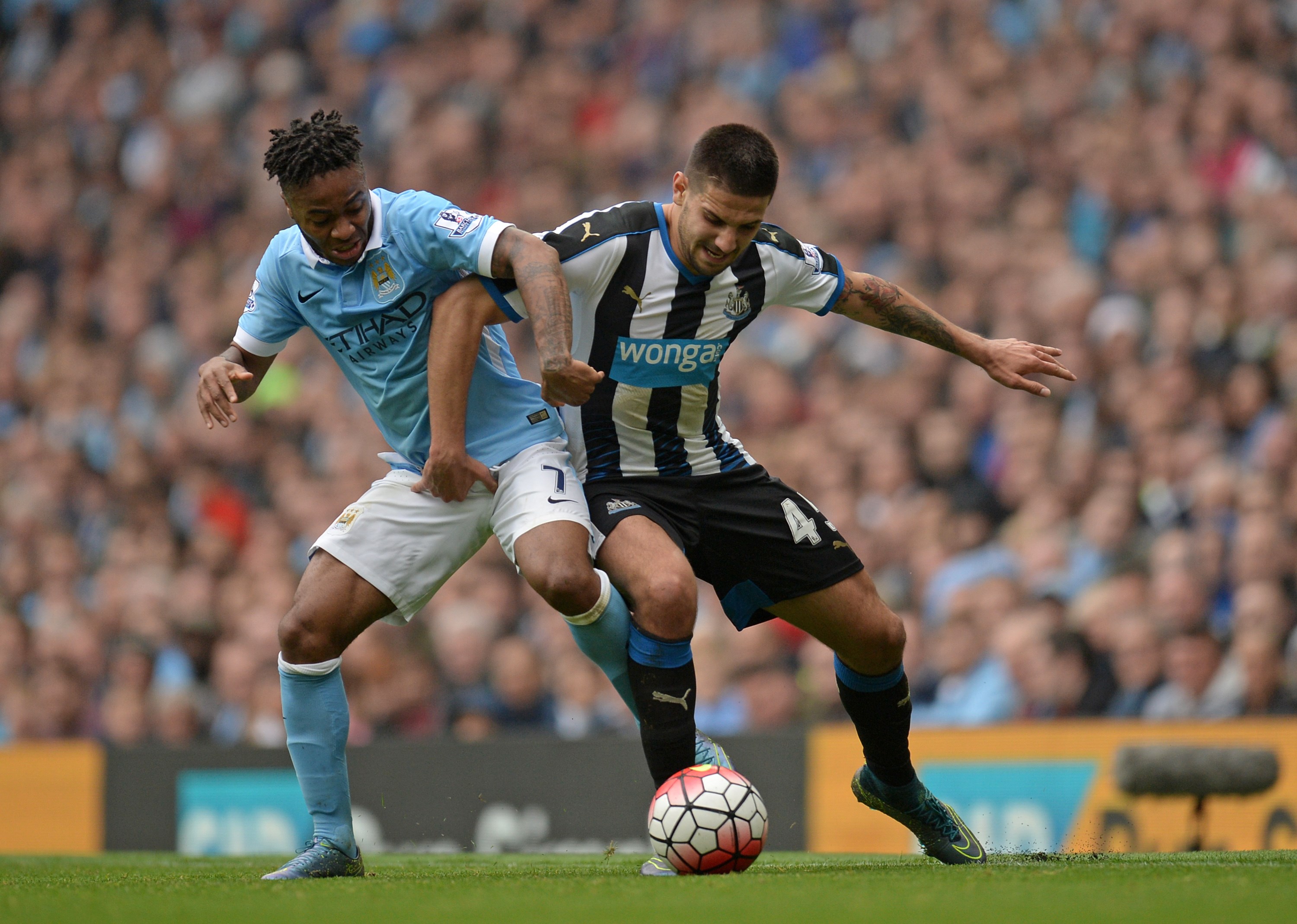 Manchester City's English midfielder Raheem Sterling (L) vies with Newcastle United's Serbian striker Aleksandar Mitrovic during the English Premier League football match between Manchester City and Newcastle United at The Etihad Stadium in Manchester, north west England on October 3, 2015. AFP PHOTO / OLI SCARFF

RESTRICTED TO EDITORIAL USE. No use with unauthorized audio, video, data, fixture lists, club/league logos or 'live' services. Online in-match use limited to 75 images, no video emulation. No use in betting, games or single club/league/player publications.        (Photo credit should read OLI SCARFF/AFP/Getty Images)