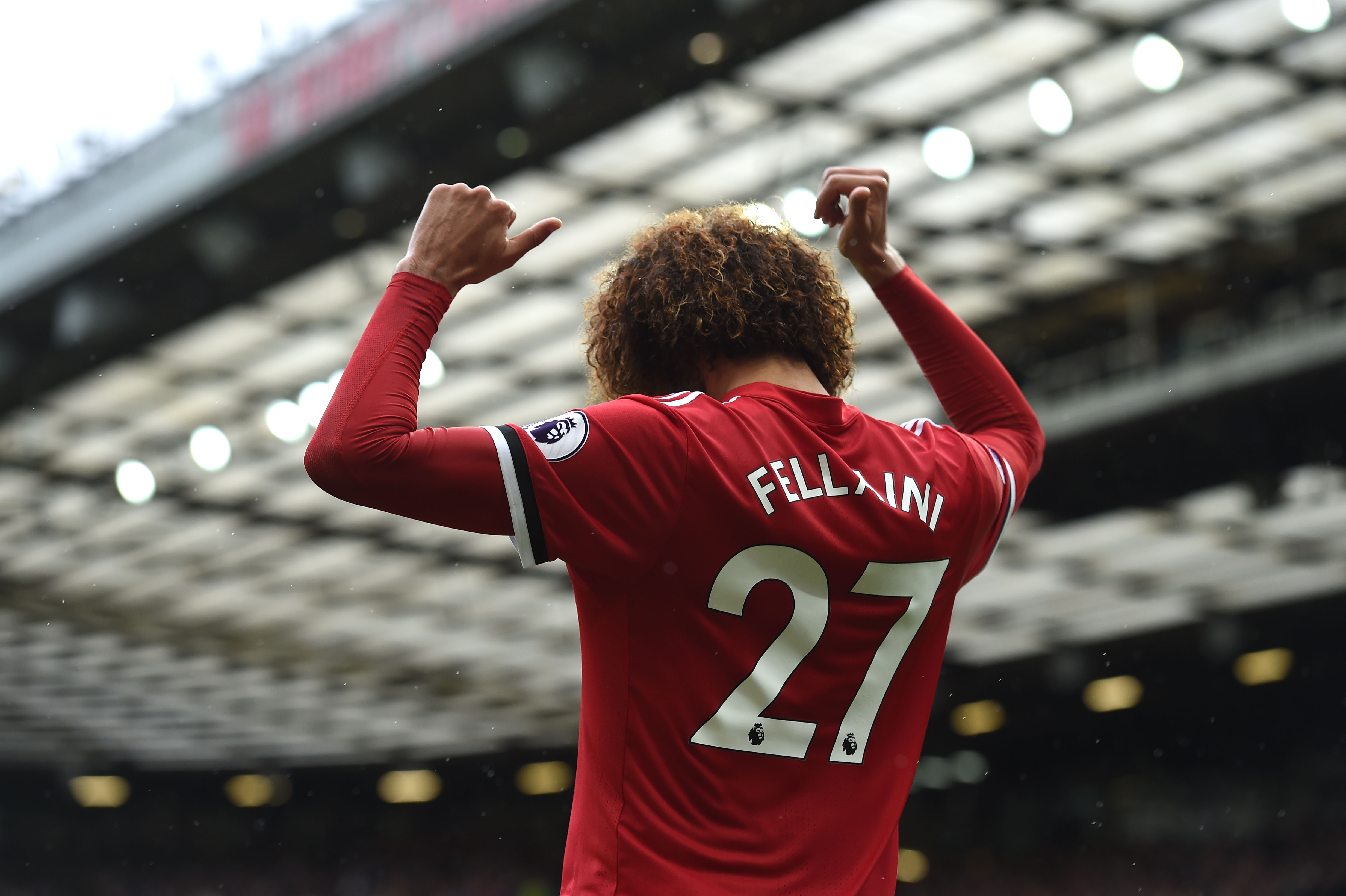 Manchester United's Belgian midfielder Marouane Fellaini celebrates scoring  the team's second goal during the English Premier League football match between Manchester United and Crystal Palace at Old Trafford in Manchester, north west England, on September 30, 2017. / AFP PHOTO / PAUL ELLIS / RESTRICTED TO EDITORIAL USE. No use with unauthorized audio, video, data, fixture lists, club/league logos or 'live' services. Online in-match use limited to 75 images, no video emulation. No use in betting, games or single club/league/player publications.  /         (Photo credit should read PAUL ELLIS/AFP/Getty Images)