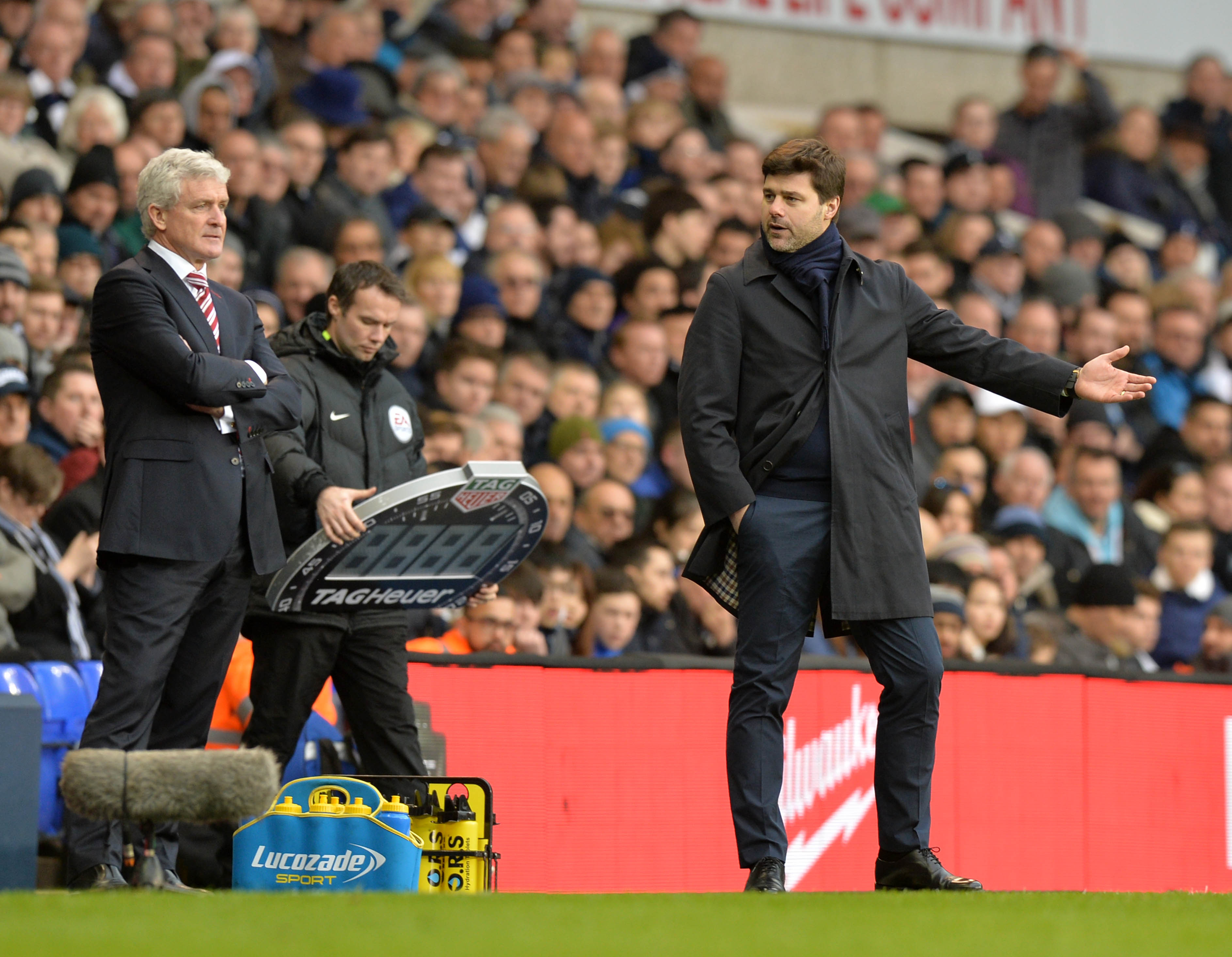 Tottenham Hotspur's Argentinian head coach Mauricio Pochettino (R) gestures as he talks with Stoke City's Welsh manager Mark Hughes (L) during the English Premier League football match between Tottenham Hotspur and Stoke City at White Hart Lane in London, on February 26, 2017. / AFP / OLLY GREENWOOD / RESTRICTED TO EDITORIAL USE. No use with unauthorized audio, video, data, fixture lists, club/league logos or 'live' services. Online in-match use limited to 75 images, no video emulation. No use in betting, games or single club/league/player publications.  /         (Photo credit should read OLLY GREENWOOD/AFP/Getty Images)
