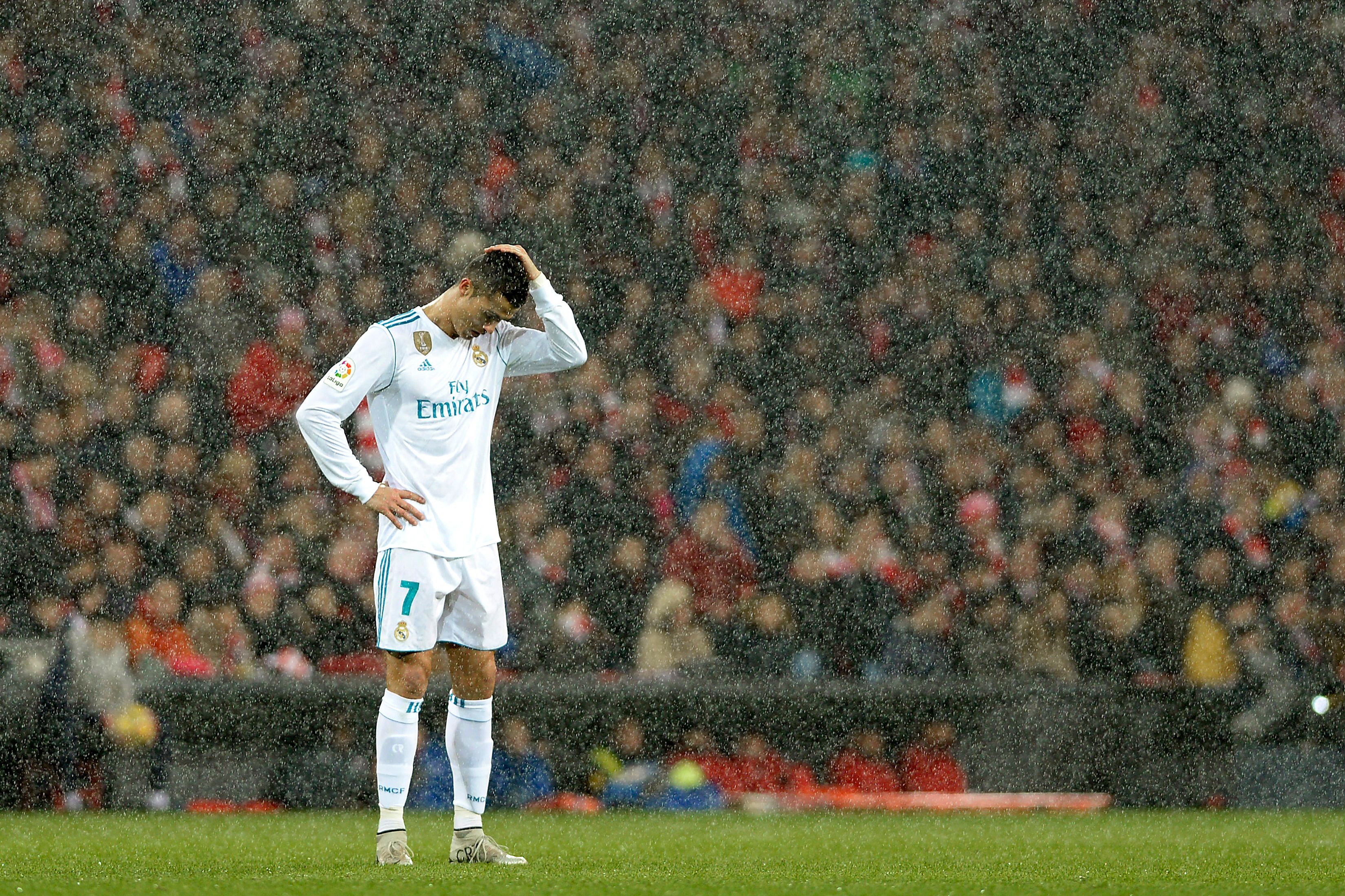 Real Madrid's Portuguese forward Cristiano Ronaldo reacts as snow falls during the Spanish league football match Athletic Club Bilbao vs Real Madrid CF at the San Mames stadium in Bilbao on December 2, 2017.  / AFP PHOTO / Ander GILLENEA        (Photo credit should read ANDER GILLENEA/AFP/Getty Images)