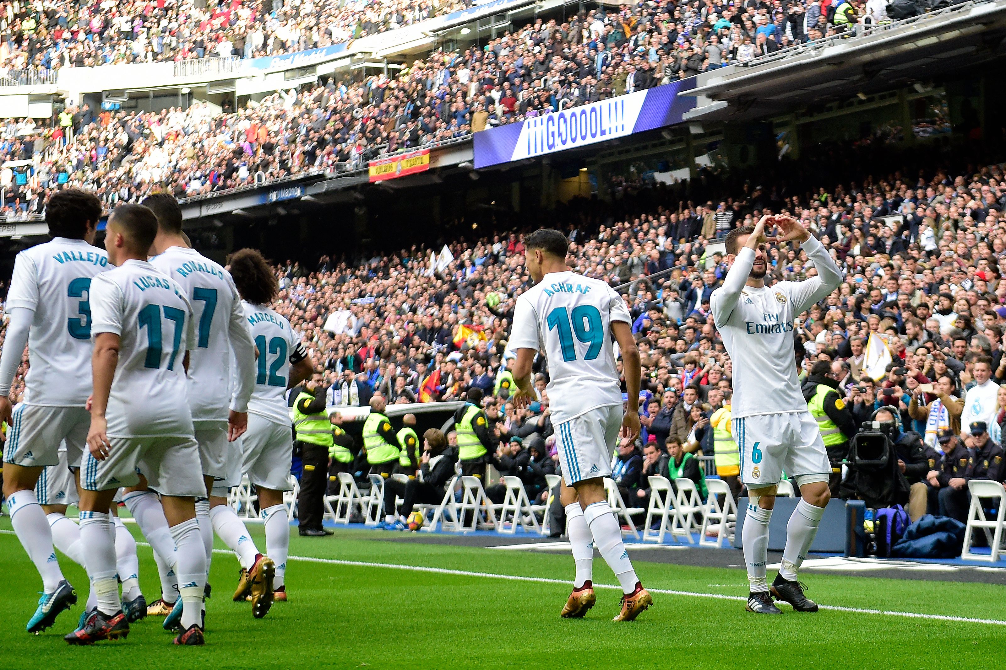 Real Madrid's Spanish defender Nacho Fernandez (R) celebrates after scoring a goal during the Spanish league football match between Real Madrid and Sevilla at the Santiago Bernabeu Stadium in Madrid on December 9, 2017. / AFP PHOTO / PIERRE-PHILIPPE MARCOU