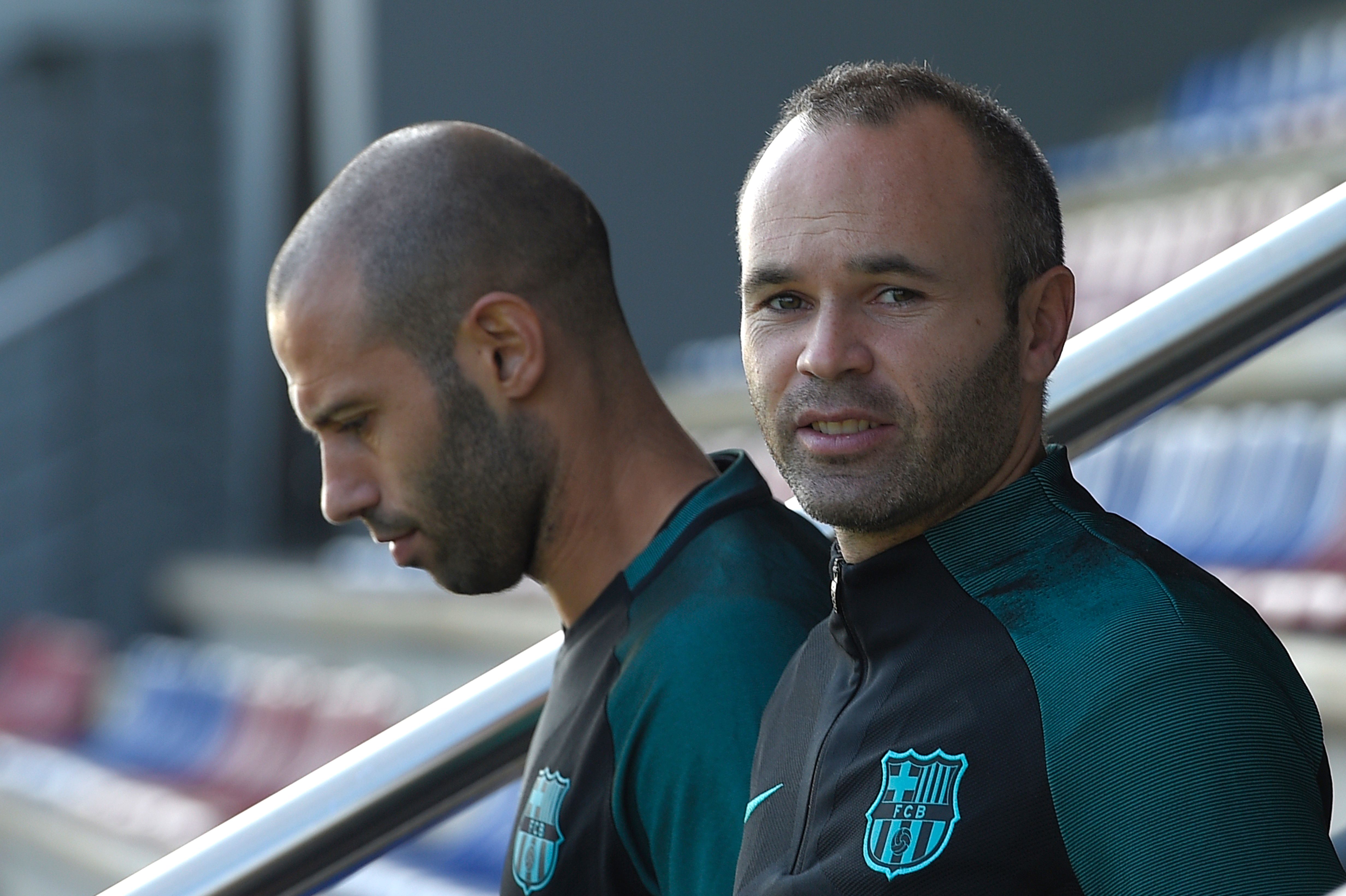Barcelona's midfielder Andres Iniesta (R) and Barcelona's Argentinian defender Javier Mascherano arrive for a training session at the Sports Center FC Barcelona Joan Gamper in Sant Joan Despi, near Barcelona on October 18, 2016, on the eve of the UEFA Champions League football match FC Barcelona vs Manchester City. / AFP / LLUIS GENE        (Photo credit should read LLUIS GENE/AFP/Getty Images)