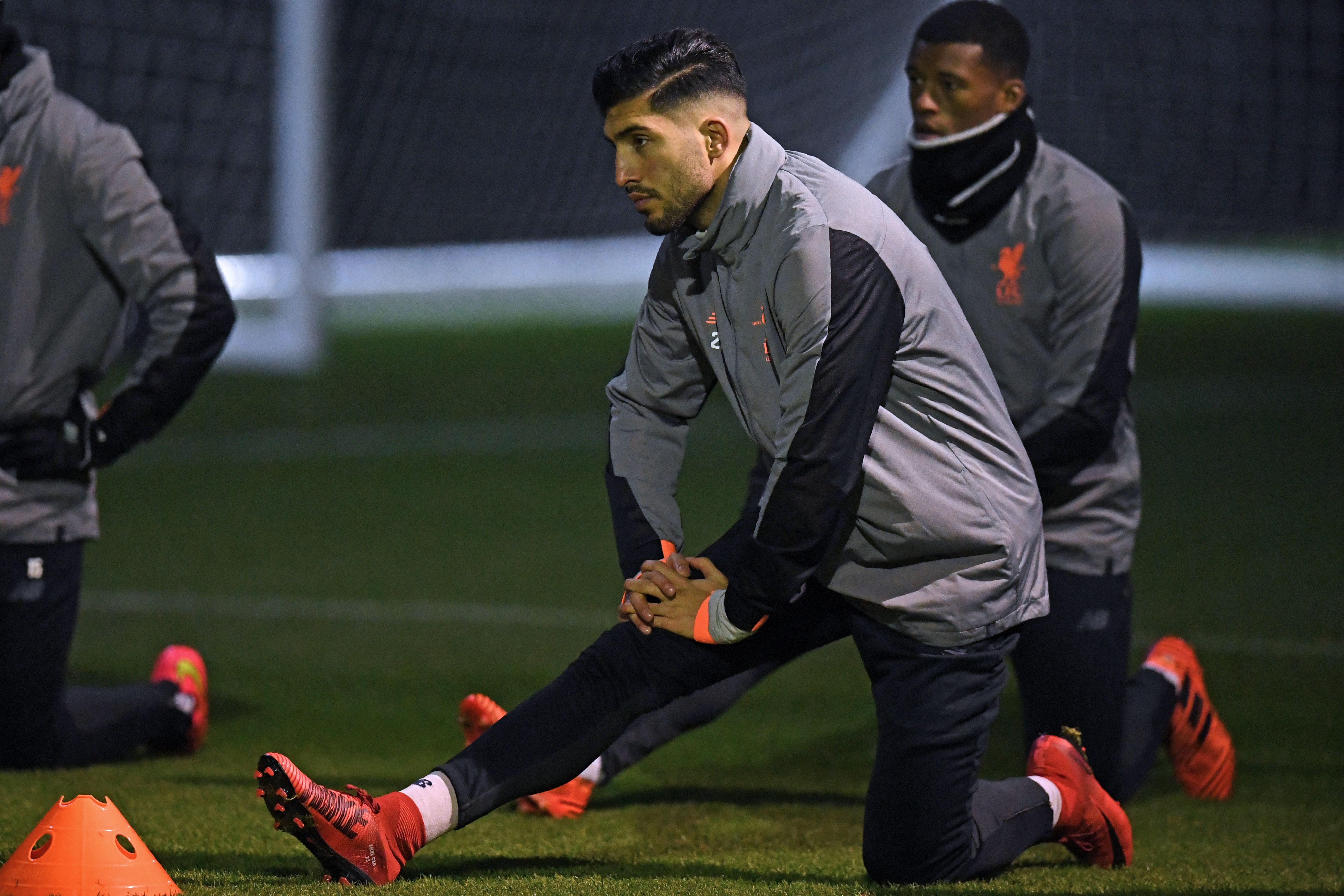 Liverpool's German midfielder Emre Can does stretching exercises during a team training session under the floodlights at their Melwood training complex in Liverpool, north west England, on December 5, 2017, on the eve of their UEFA Champions League group E football match against Spartak Moscow. / AFP PHOTO / Paul ELLIS        (Photo credit should read PAUL ELLIS/AFP/Getty Images)