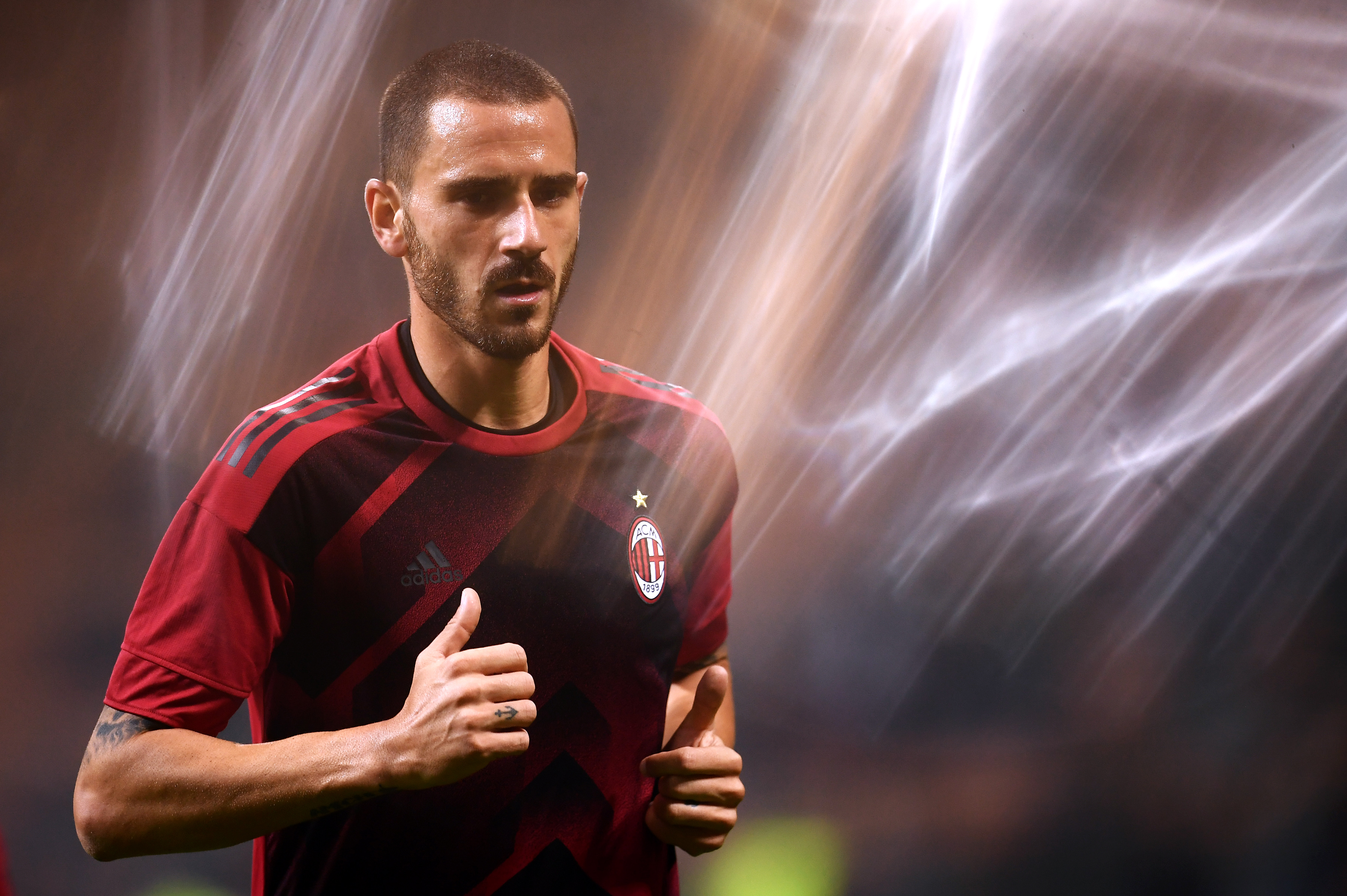 AC Milan's defender Leonardo Bonucci from Italy warms up before the UEFA Europa League football match AC Milan vs AEK Athens at the "San Siro Stadium" in Milan on October 19, 2017.  / AFP PHOTO / MARCO BERTORELLO        (Photo credit should read MARCO BERTORELLO/AFP/Getty Images)