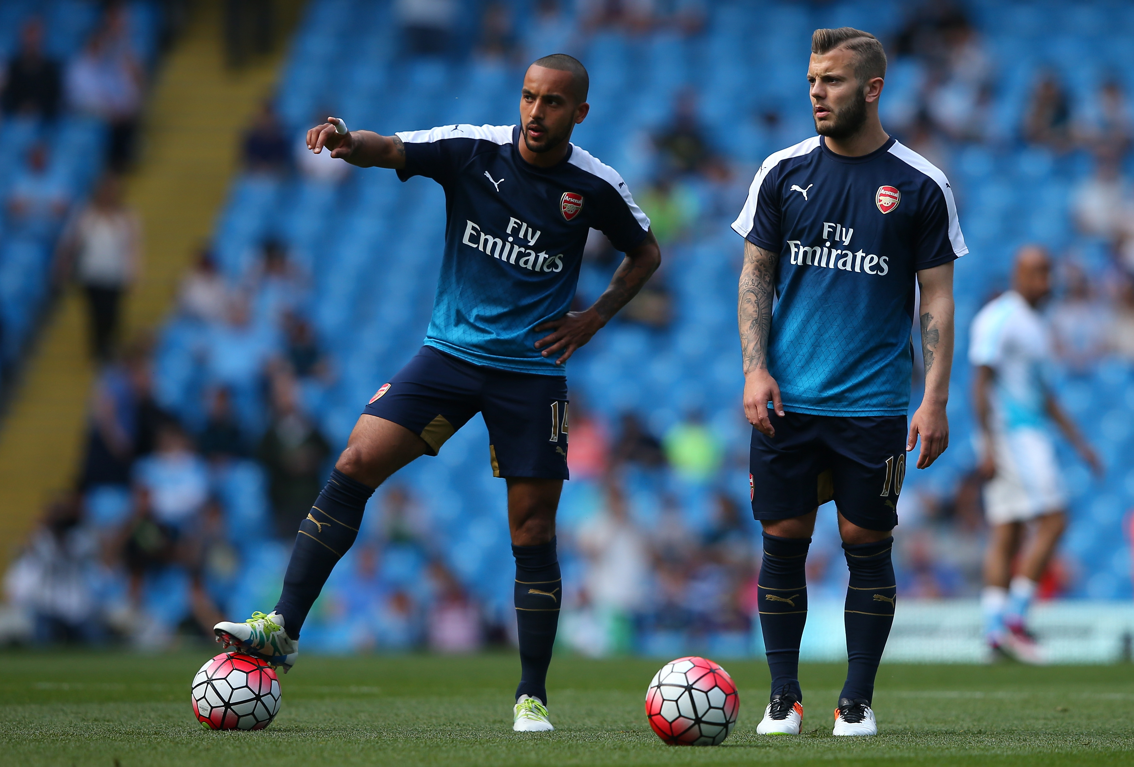 MANCHESTER, ENGLAND - MAY 08:  Theo Walcott of Arsenal (L) and Jack Wilshere of Arsenal warm up prior to the Barclays Premier League match between Manchester City and Arsenal at the Etihad Stadium on May 8, 2016 in Manchester, England.  (Photo by Alex Livesey/Getty Images)