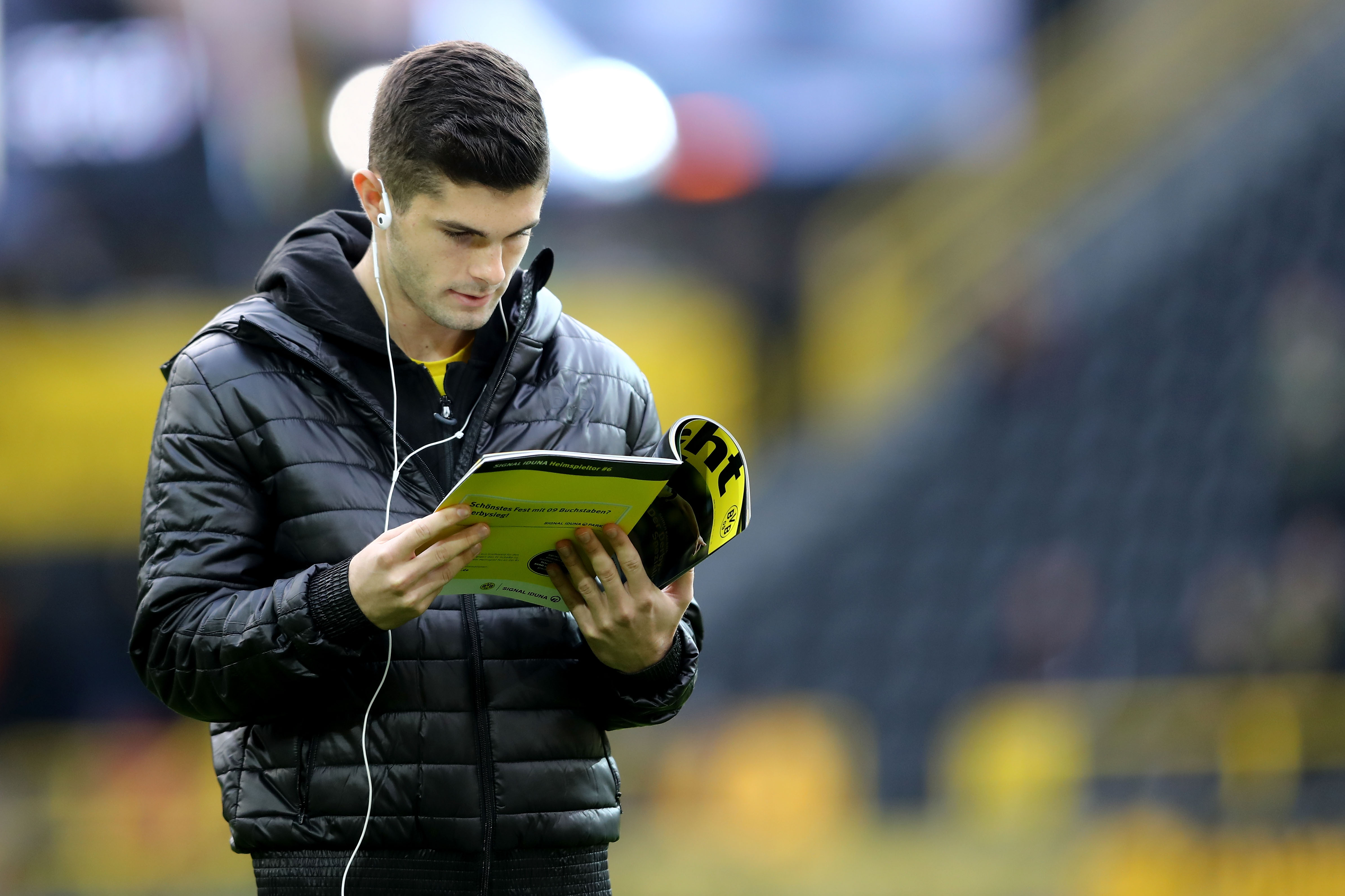 DORTMUND, GERMANY - NOVEMBER 25: Christian Pulisic of Dortmund reads a magazin prior to the Bundesliga match between Borussia Dortmund and FC Schalke 04 at Signal Iduna Park on November 25, 2017 in Dortmund, Germany.  (Photo by Christof Koepsel/Bongarts/Getty Images)