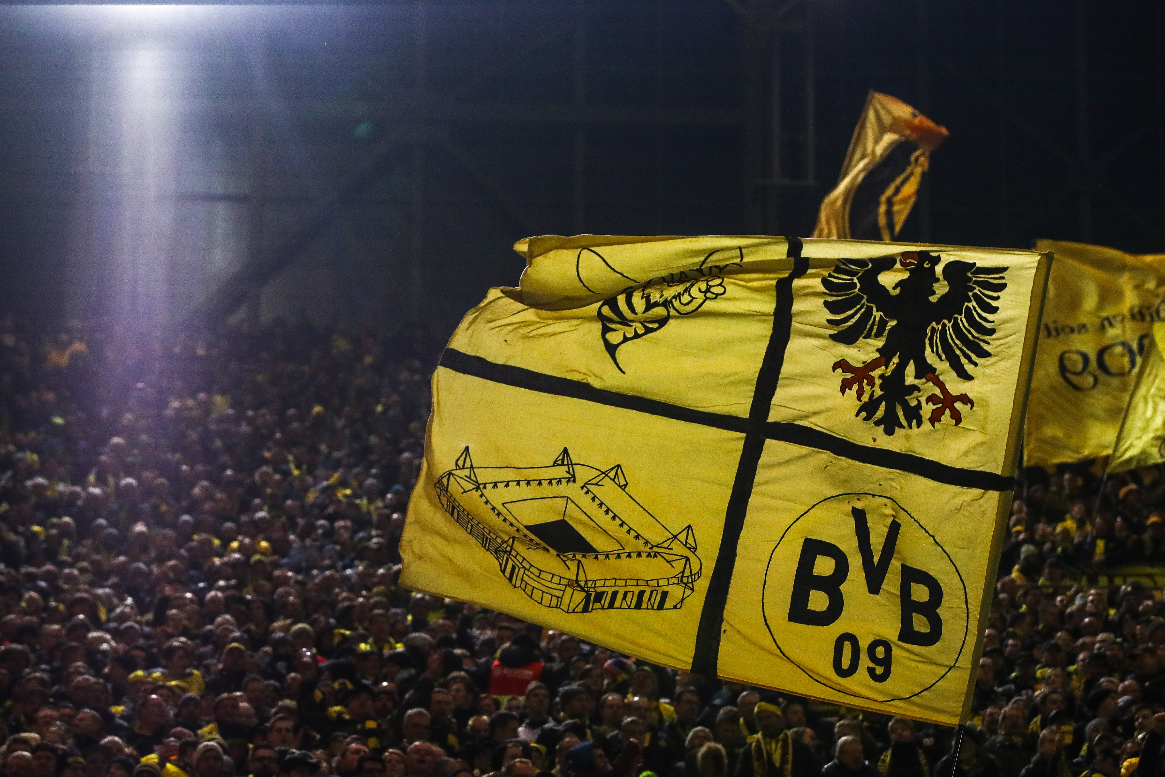 DORTMUND, GERMANY - JANUARY 14: Fans of Dortmund wave their flags at the "Sudtribune" (South Stand) known as the Yellow Wall prior the Bundesliga match between Borussia Dortmund and VfL Wolfsburg at Signal Iduna Park on January 14, 2018 in Dortmund, Germany. (Photo by Maja Hitij/Bongarts/Getty Images)
