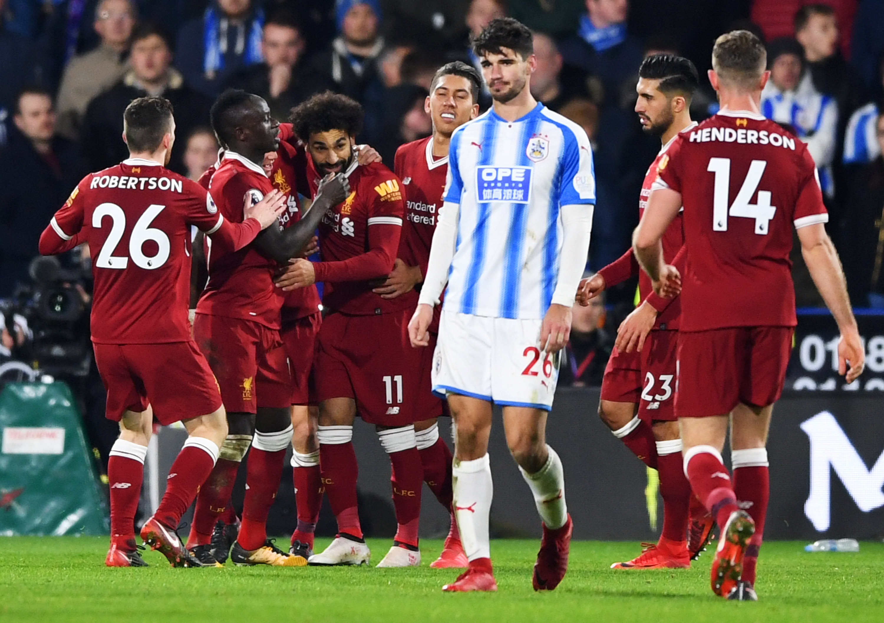 HUDDERSFIELD, ENGLAND - JANUARY 30:  Mohamed Salah of Liverpool (11) celebrates as he scores their third goal from the penalty spot with team mates during the Premier League match between Huddersfield Town and Liverpool at John Smith's Stadium on January 30, 2018 in Huddersfield, England.  (Photo by Gareth Copley/Getty Images)
