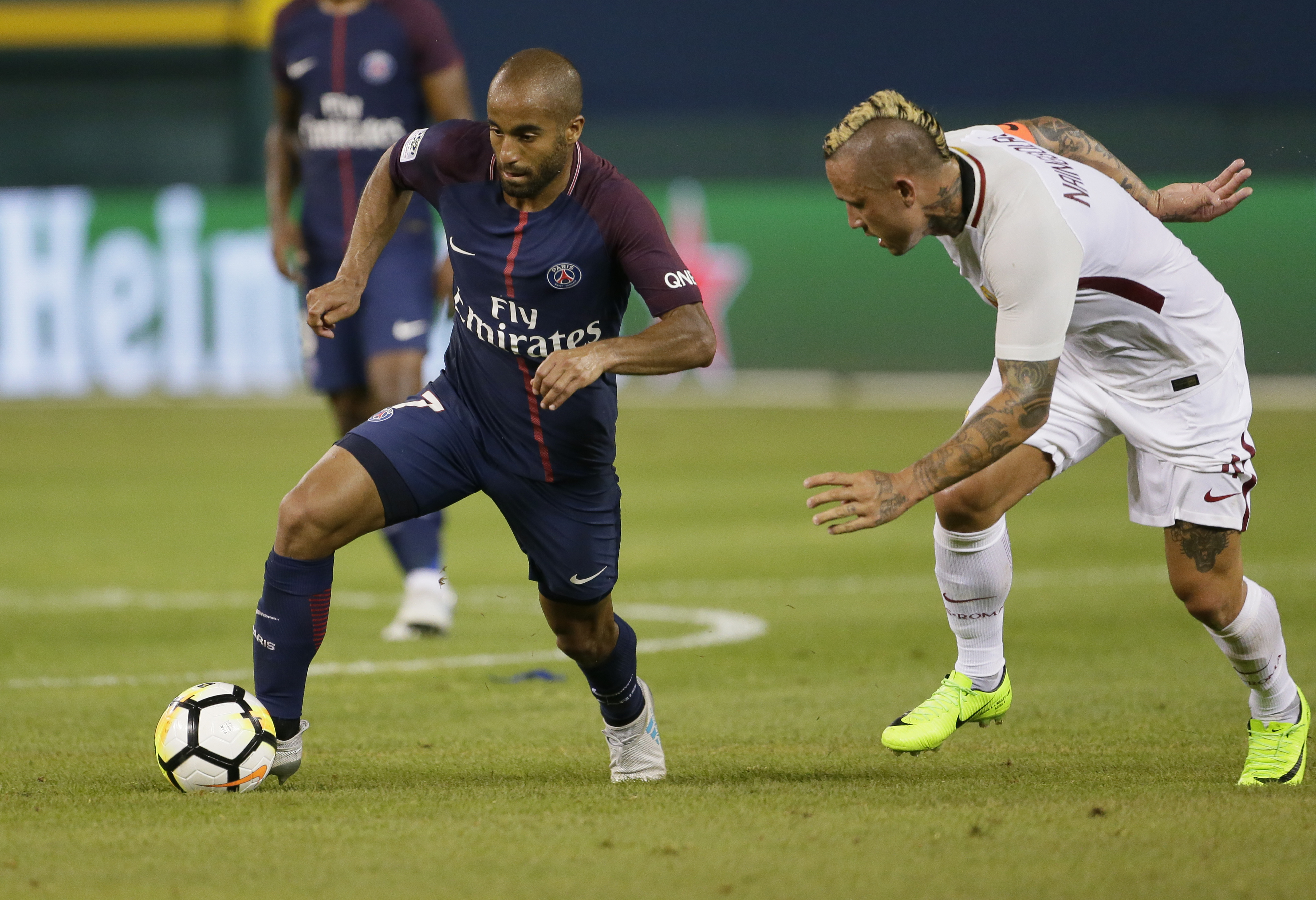DETROIT, MI - JULY 19:  Lucas Moura #7 of Paris Saint-Germain tries to break away from Radja Nainggolan #4 of AS Roma during the second half at Comerica Park on July 19, 2017 in Detroit, Michigan. (Photo by Duane Burleson/Getty Images)