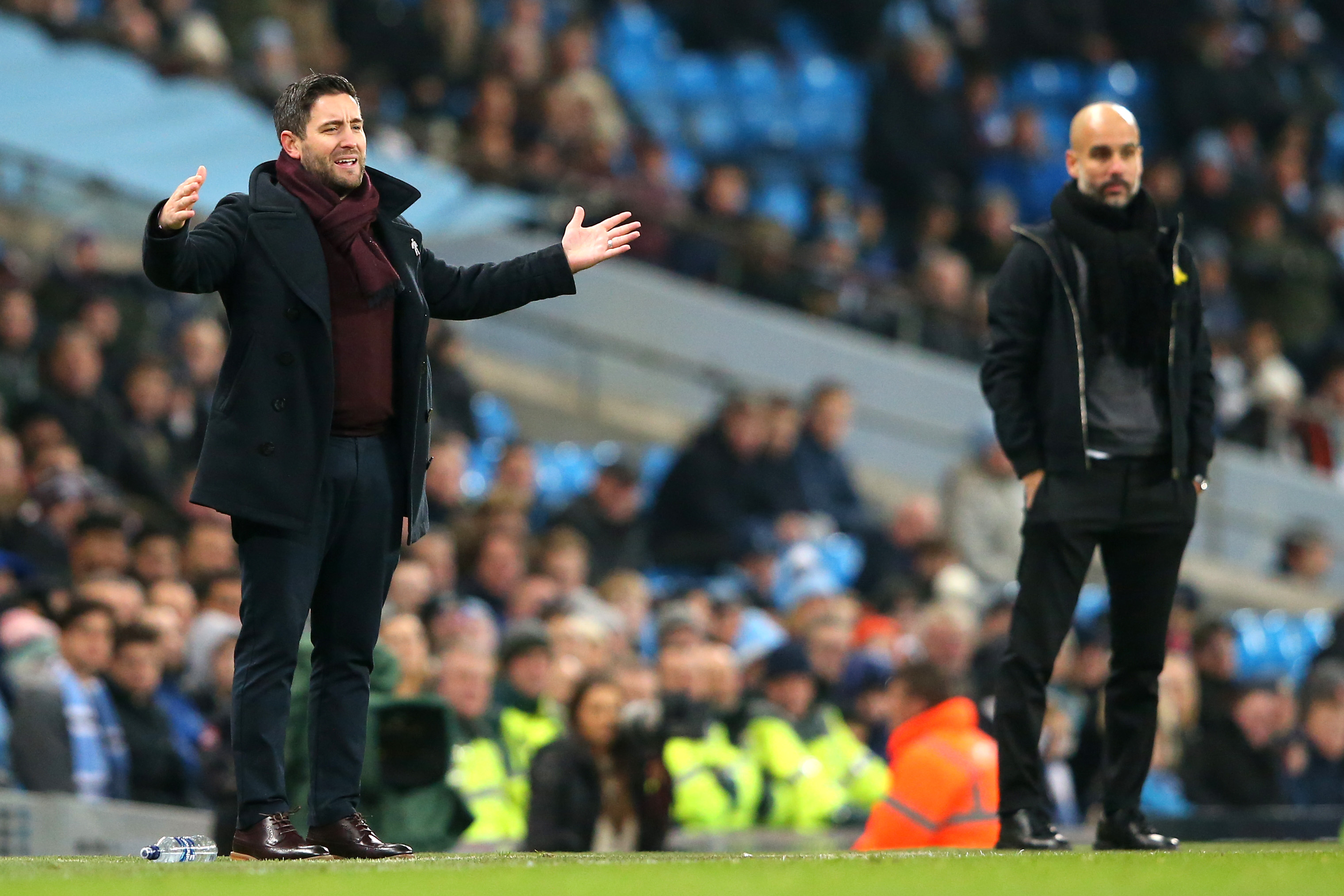 MANCHESTER, ENGLAND - JANUARY 09:  Lee Johnson, manager of Bristol City reacts as Josep Guardiola, Manager of Manchester City looks on during the Carabao Cup Semi-Final First Leg match between Manchester City and Bristol City at Etihad Stadium on January 9, 2018 in Manchester, England.  (Photo by Alex Livesey/Getty Images)