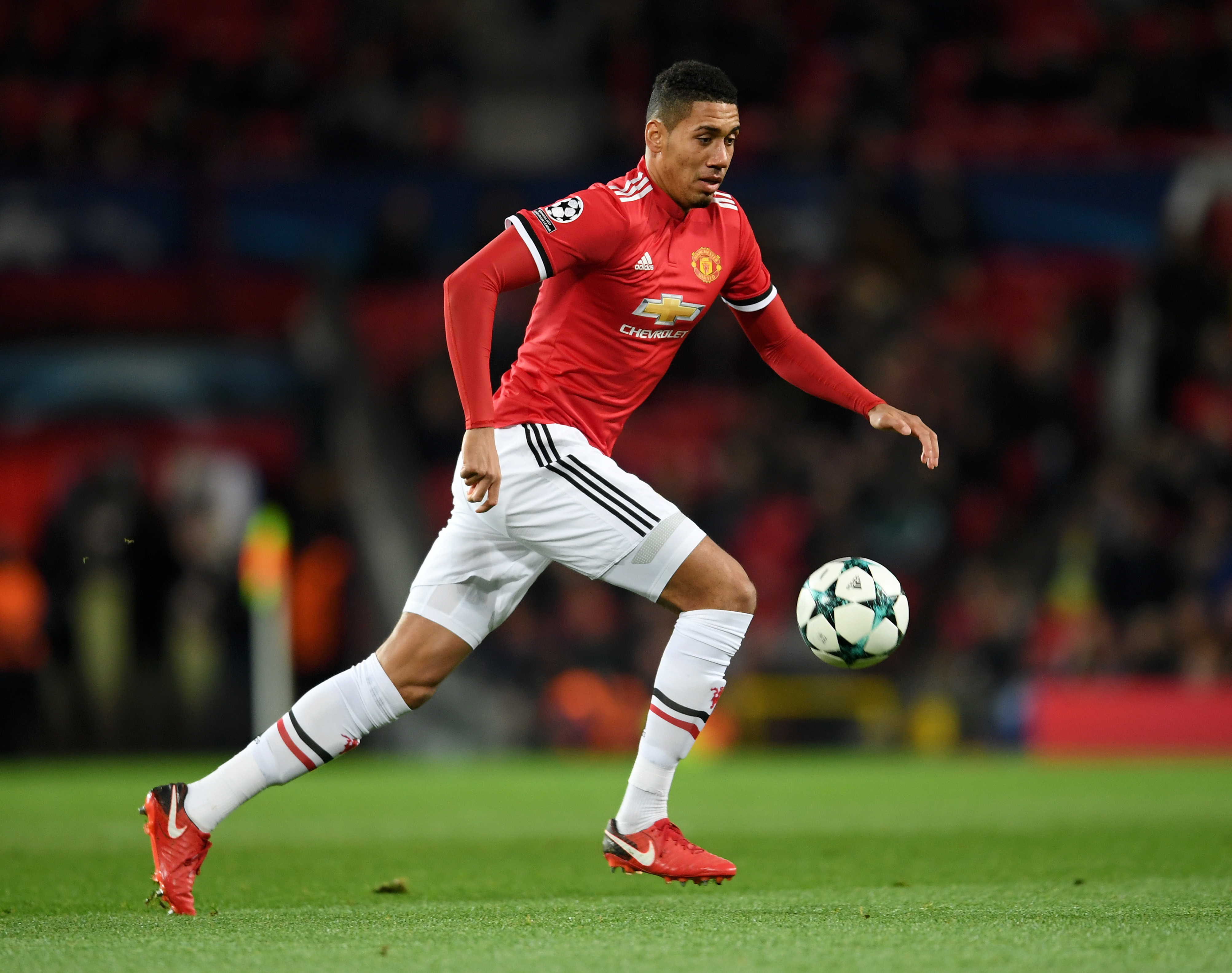 MANCHESTER, ENGLAND - DECEMBER 05: Chris Smalling of Manchester United runs with the ball during the UEFA Champions League group A match between Manchester United and CSKA Moskva at Old Trafford on December 05, 2017 in Manchester, United Kingdom. (Photo by Laurence Griffiths/Getty Images)