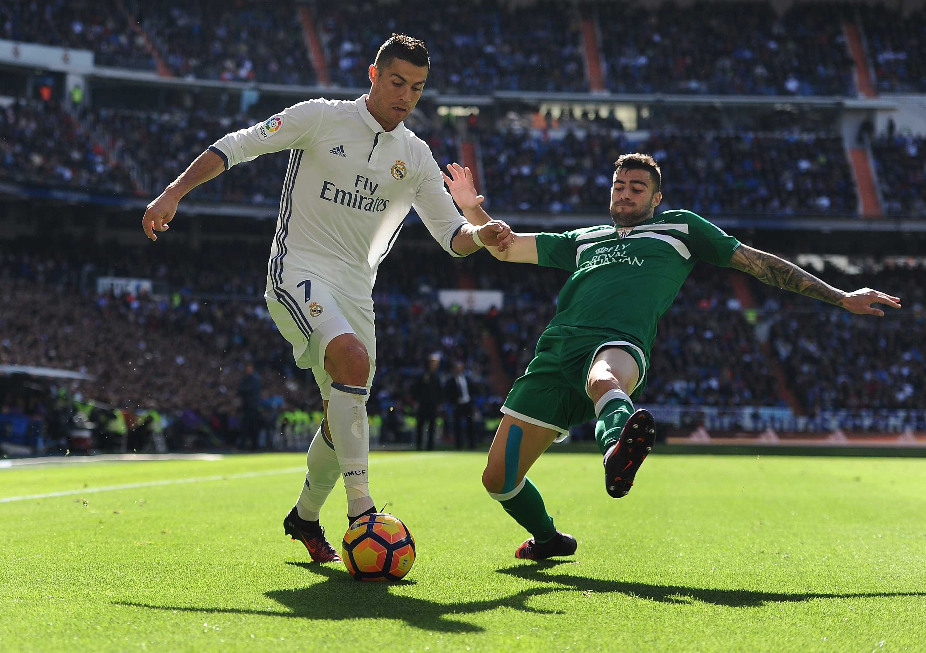 MADRID, SPAIN - NOVEMBER 06:  Cristiano Ronaldo of Real Madrid is tackled by Diego Rico of CD Leganes controls the ball while being challenged by during the Liga match between Real Madrid CF and Leganes on November 6, 2016 in Madrid, Spain.  (Photo by Denis Doyle/Getty Images)