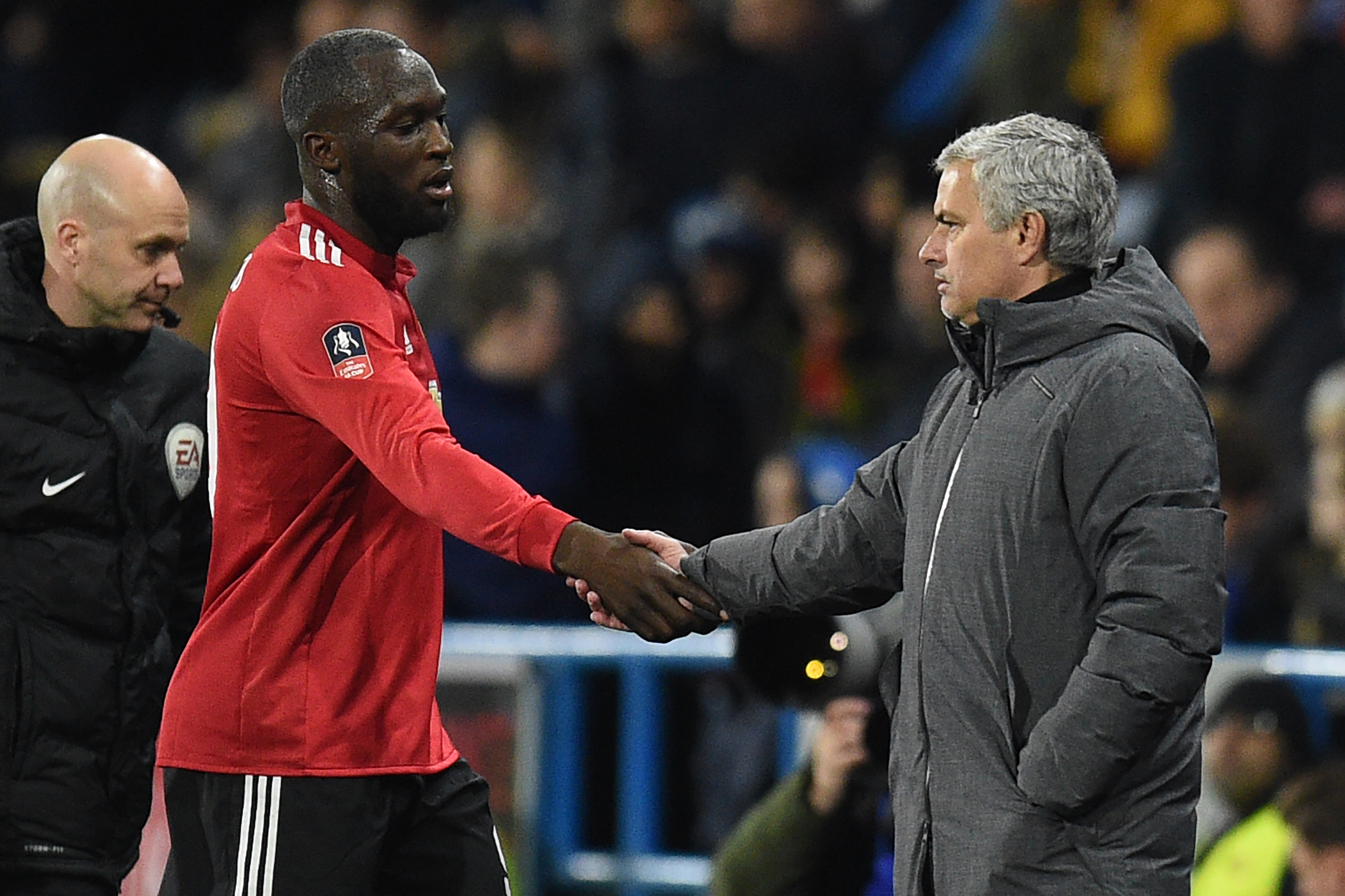 Manchester United's Portuguese manager Jose Mourinho (R) shakes hands with Manchester United's Belgian striker Romelu Lukaku as he's substituted during the English FA Cup fifth round football match between Huddersfield Town and Manchester United at the John Smith's stadium in Huddersfield, northern England on February 17, 2018.
Manchester United won the game 2-0. / AFP PHOTO / Oli SCARFF / RESTRICTED TO EDITORIAL USE. No use with unauthorized audio, video, data, fixture lists, club/league logos or 'live' services. Online in-match use limited to 75 images, no video emulation. No use in betting, games or single club/league/player publications.  /         (Photo credit should read OLI SCARFF/AFP/Getty Images)