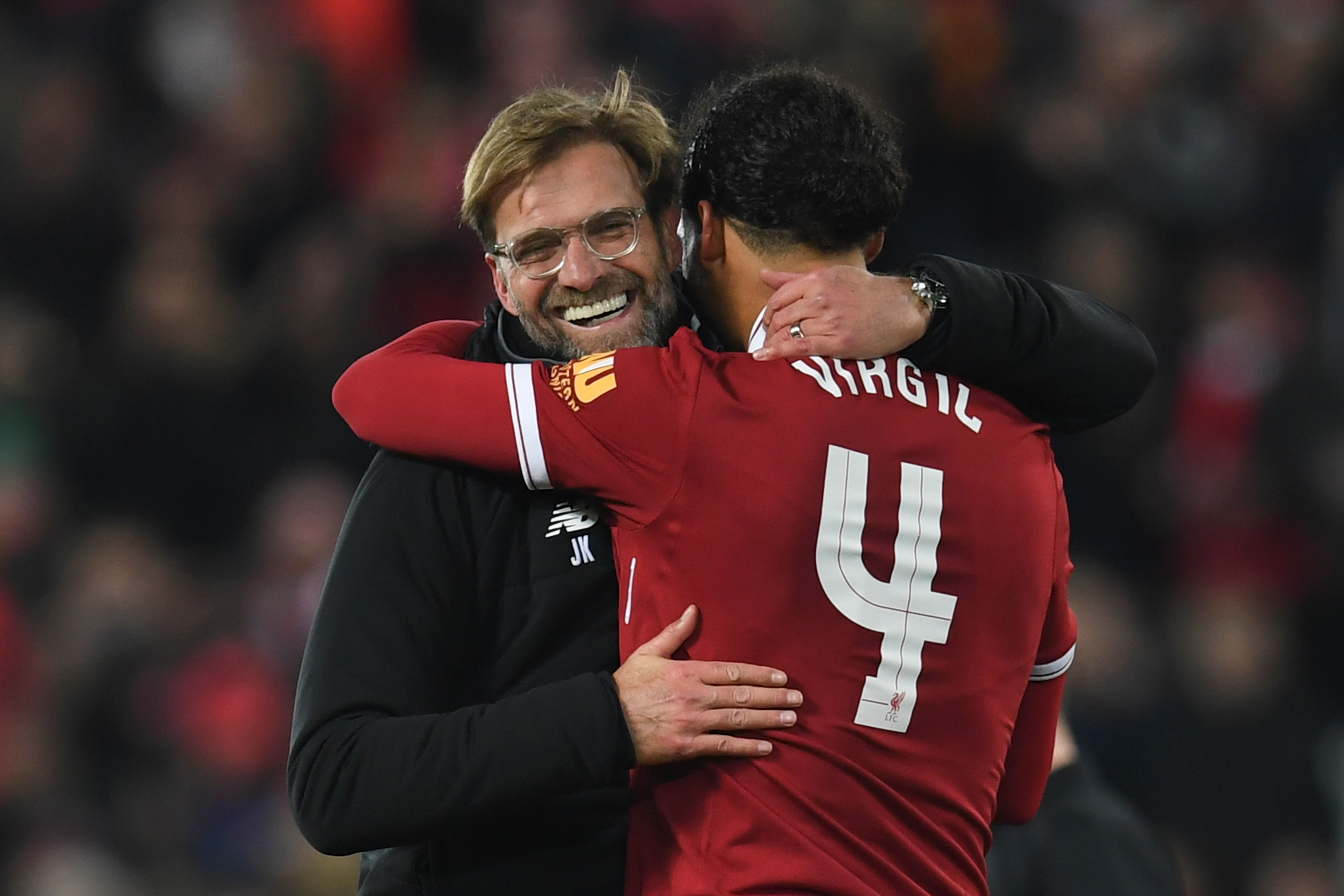 Liverpool's German manager Jurgen Klopp (L) hugs Liverpool's Dutch defender Virgil van Dijk (R) at the end of the English FA Cup third round football match between Liverpool and Everton at Anfield in Liverpool, north west England on January 5, 2018. / AFP PHOTO / Paul ELLIS / RESTRICTED TO EDITORIAL USE. No use with unauthorized audio, video, data, fixture lists, club/league logos or 'live' services. Online in-match use limited to 75 images, no video emulation. No use in betting, games or single club/league/player publications.  /         (Photo credit should read PAUL ELLIS/AFP/Getty Images)