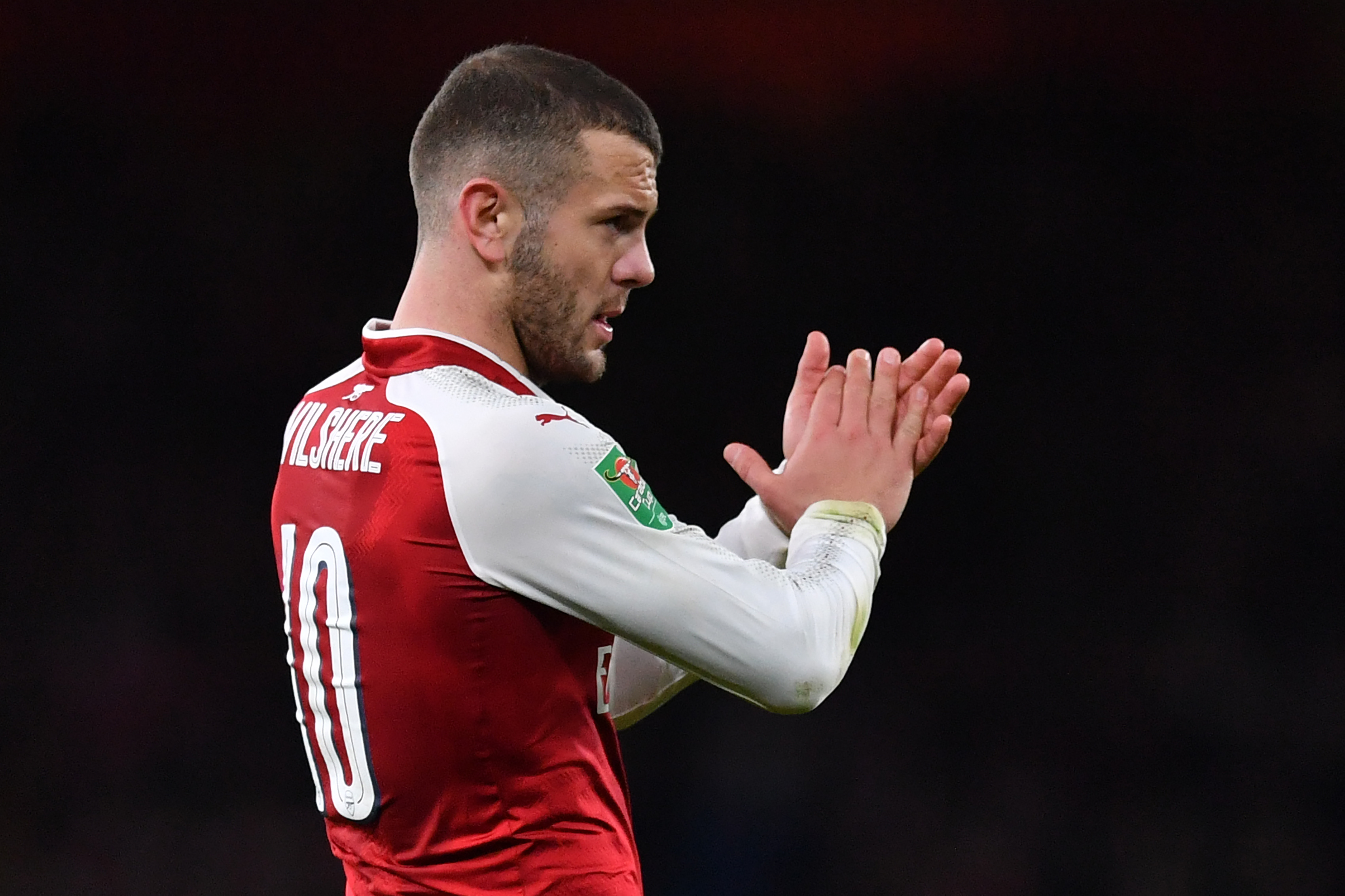 Arsenal's English midfielder Jack Wilshere gestures at the final whistle during the League Cup semi-final football match between Arsenal and Chelsea at the Emirates Stadium in London on January 24, 2018.  / AFP PHOTO / Ben STANSALL / RESTRICTED TO EDITORIAL USE. No use with unauthorized audio, video, data, fixture lists, club/league logos or 'live' services. Online in-match use limited to 75 images, no video emulation. No use in betting, games or single club/league/player publications.  /         (Photo credit should read BEN STANSALL/AFP/Getty Images)